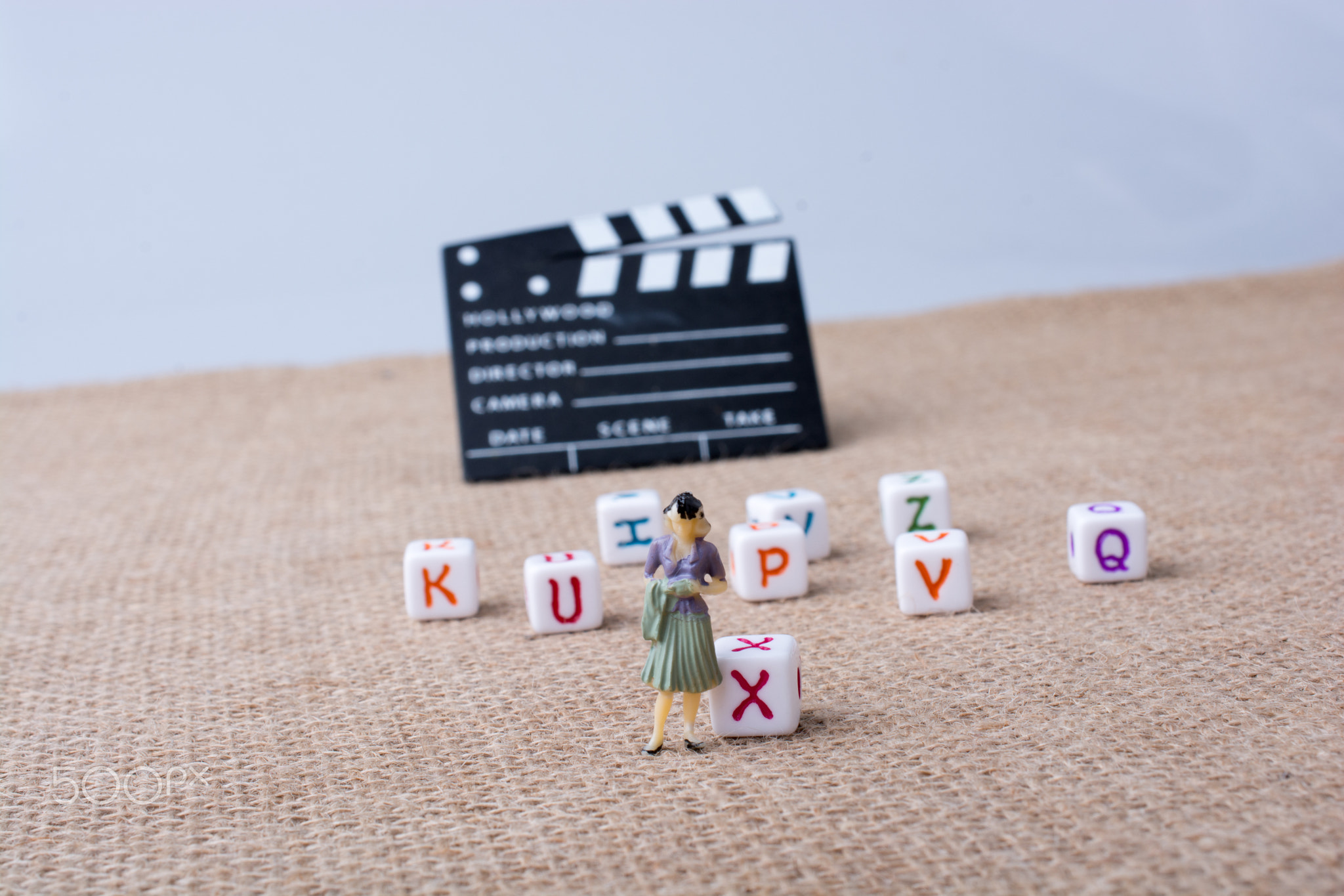 Letter cubes beside a director clapper board