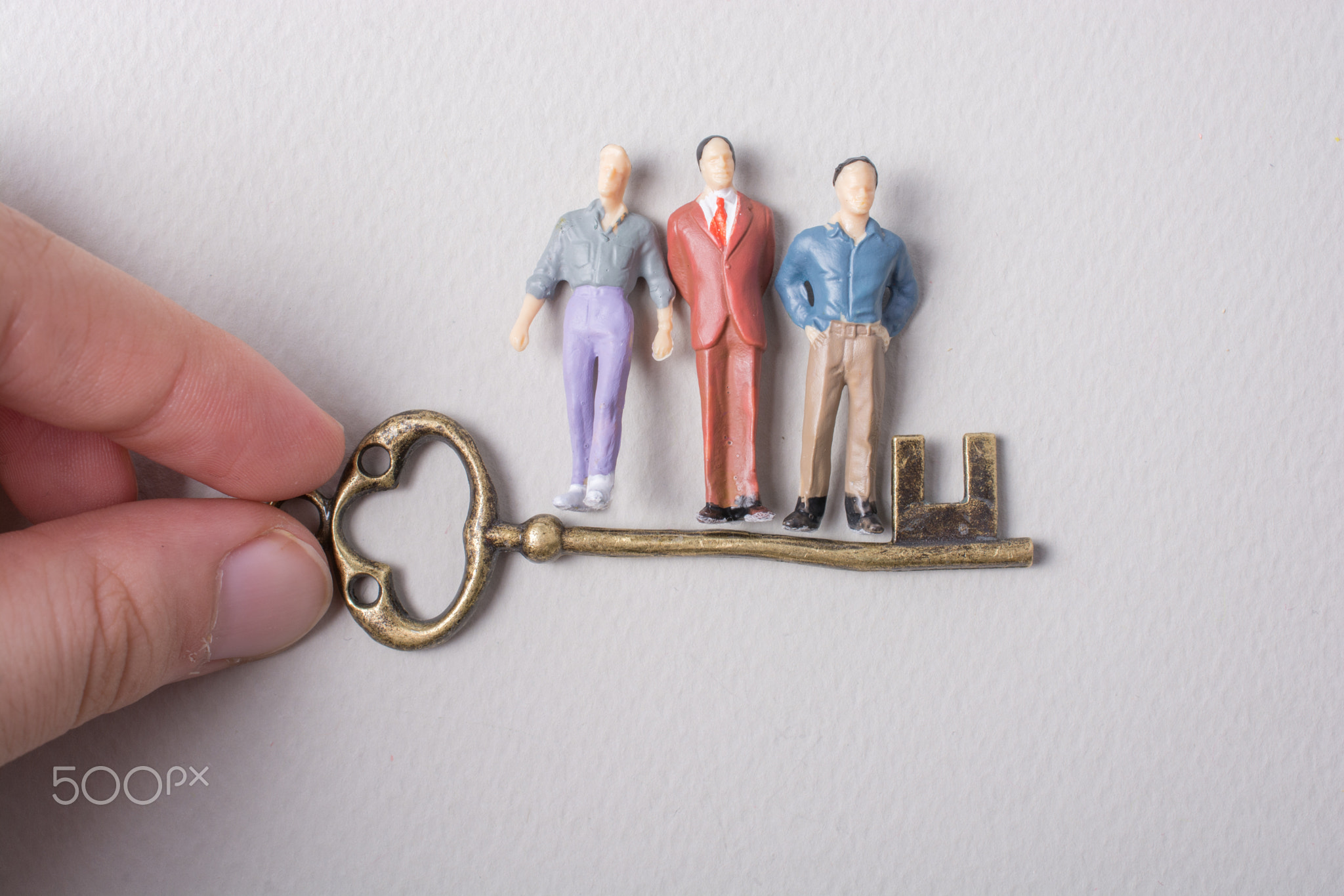 Tiny figurine of man model and retro key