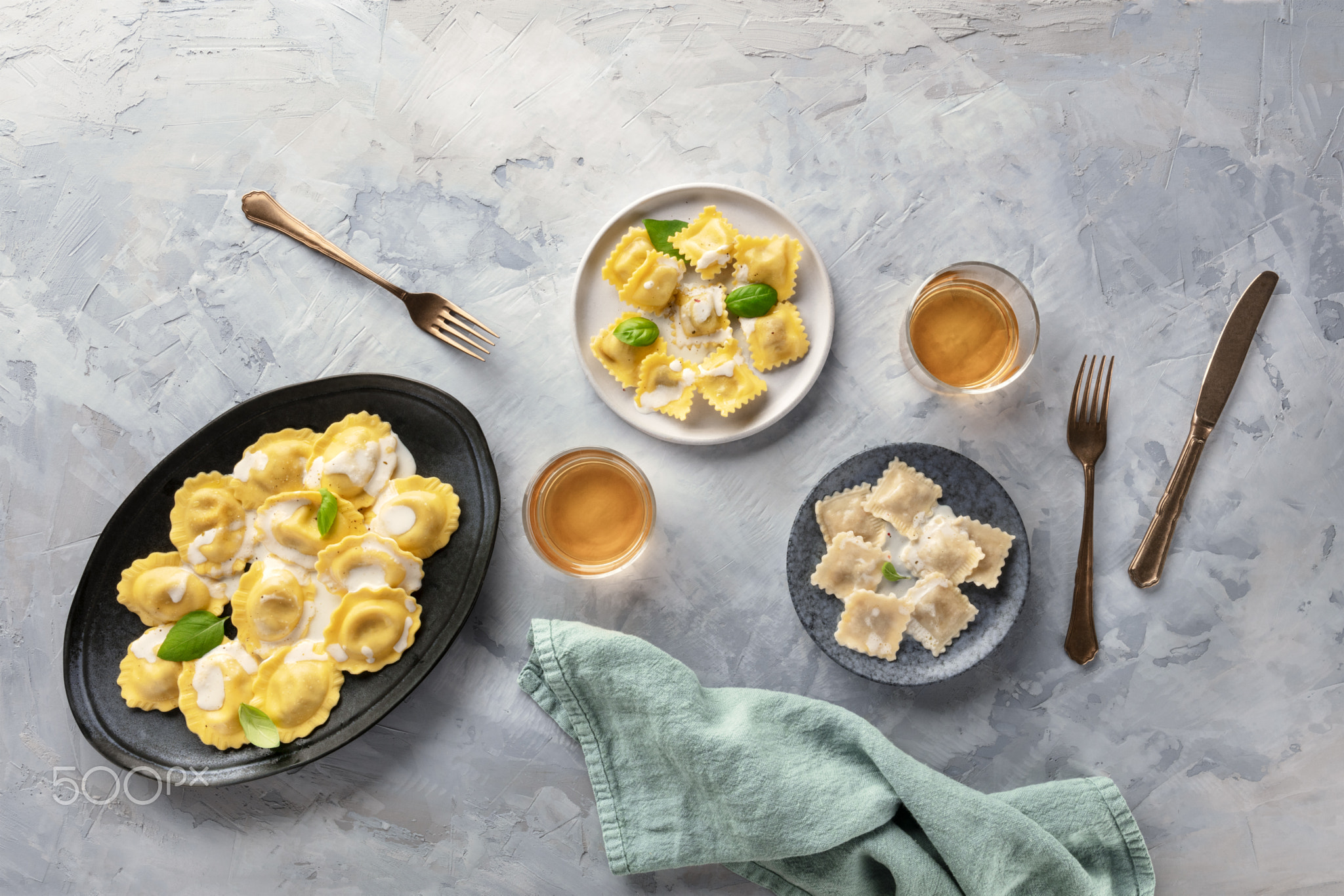 Italian Food. An assortment of various ravioli, shot from the top with white wine and a place for...