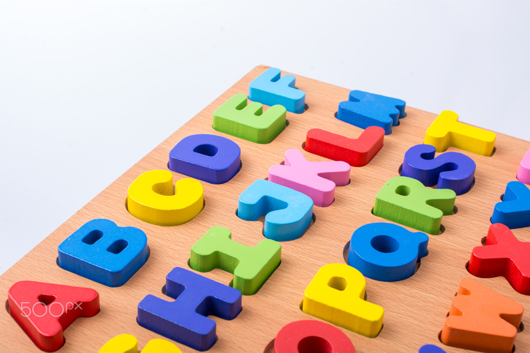 Colorful letter blocks on board on white