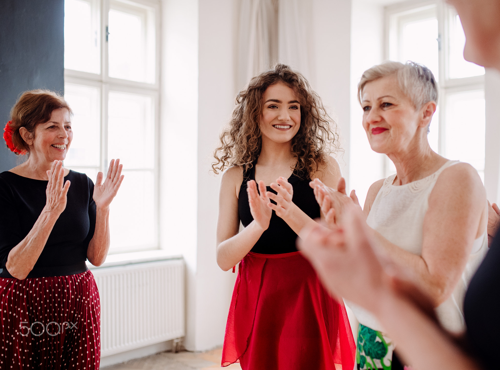 Group of senior women in dancing class with dance teacher.