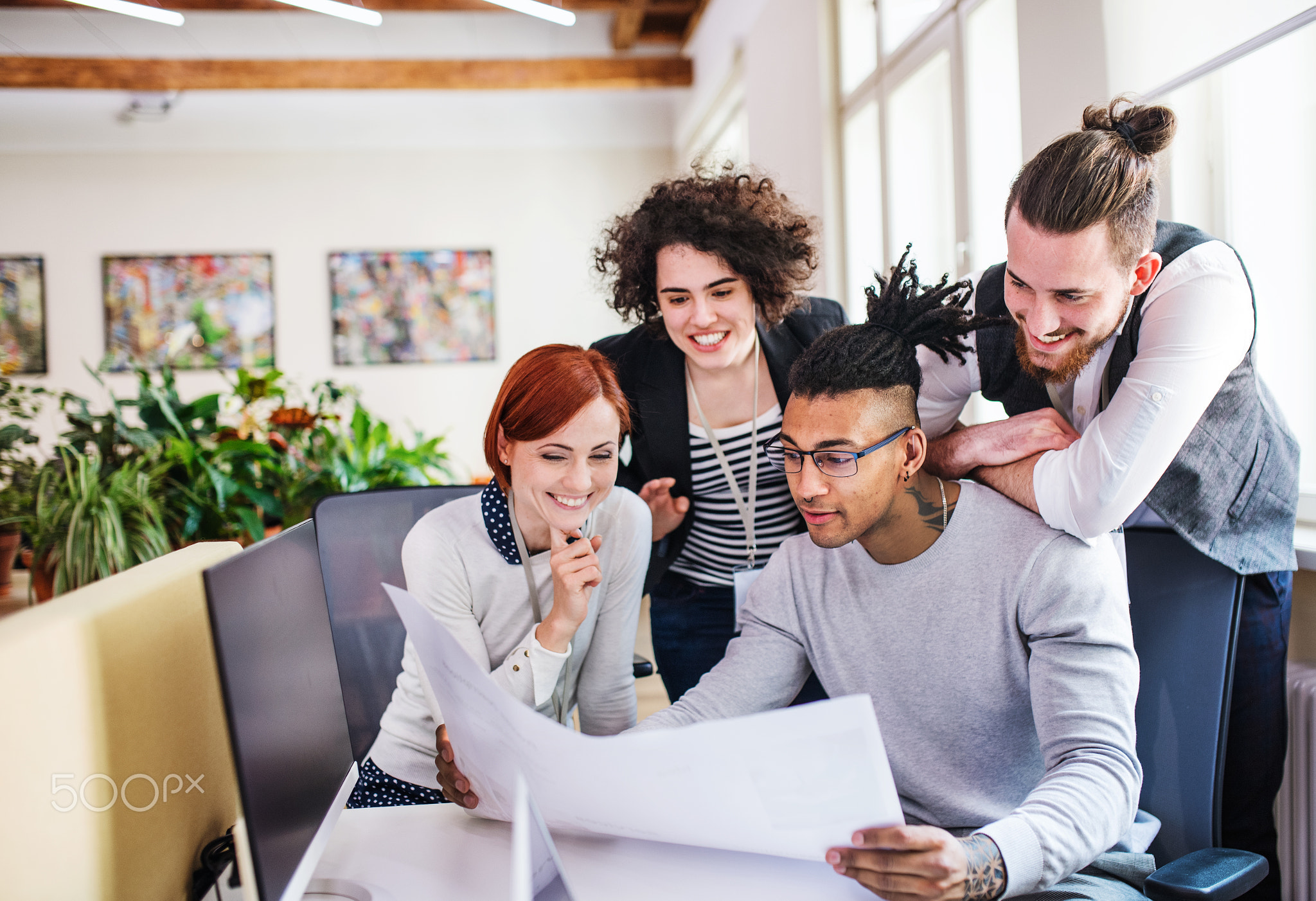 Group of young businesspeople working in office, start-up concept.
