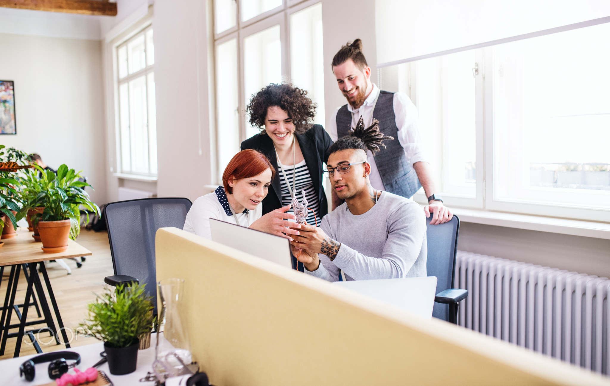 Group of young businesspeople working in office, start-up concept.