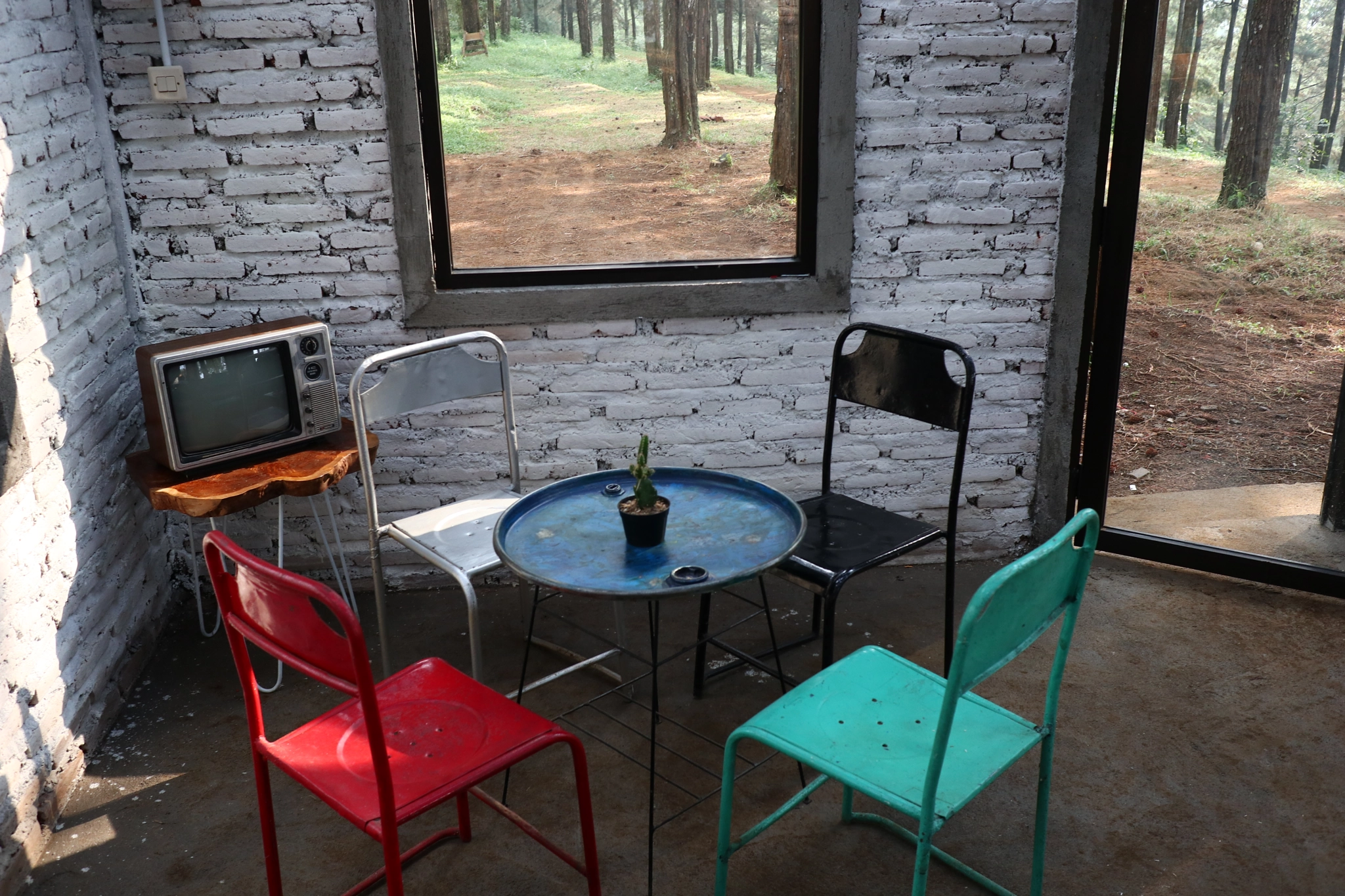 a room with an old iron chair and television