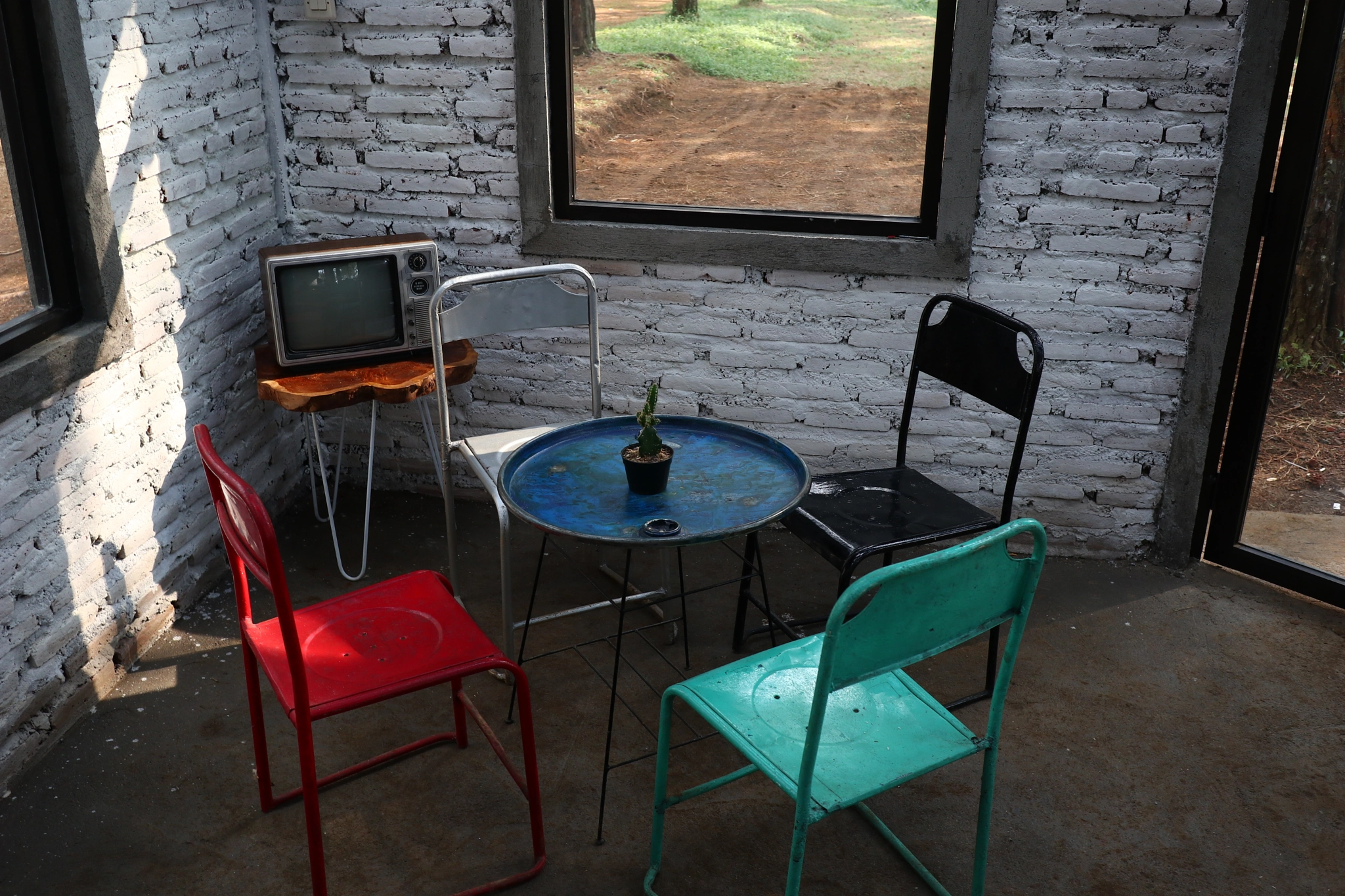 a room with an old iron chair and television