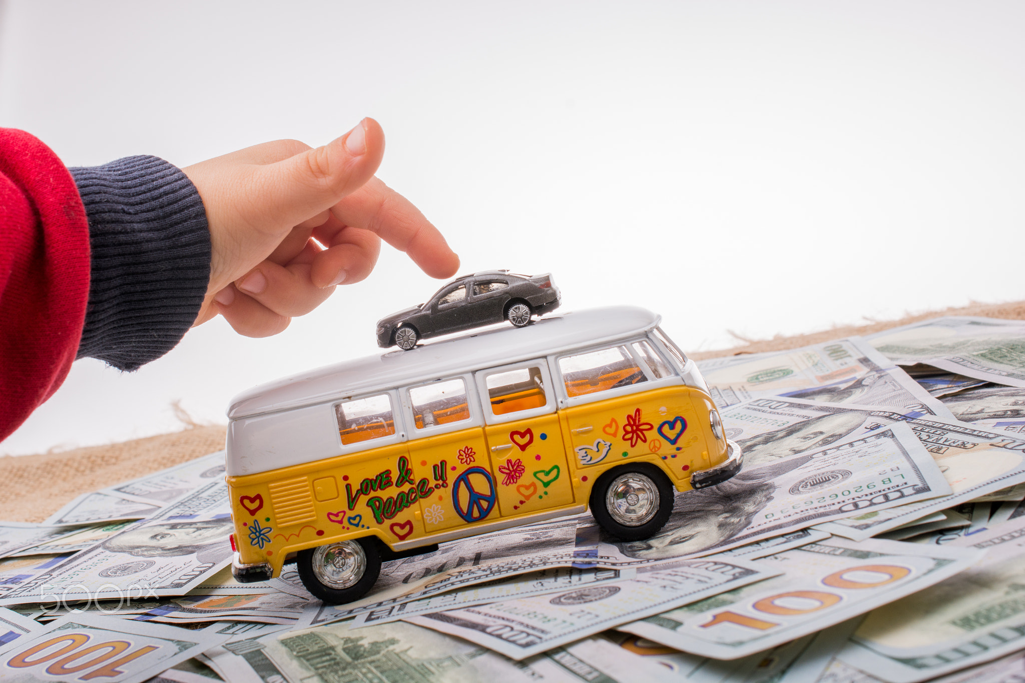 Model van and car placed US dollar banknotes