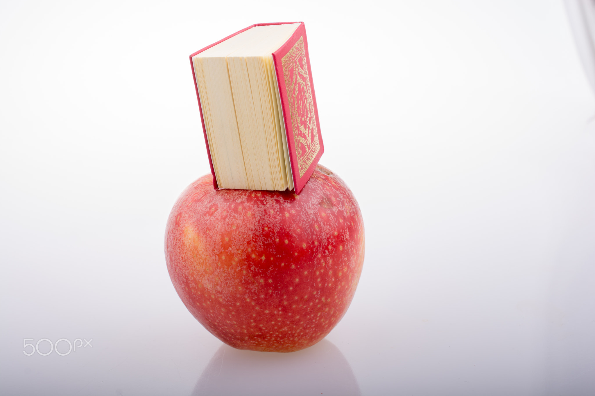 Red apple and  Islamic Holy Book Quran