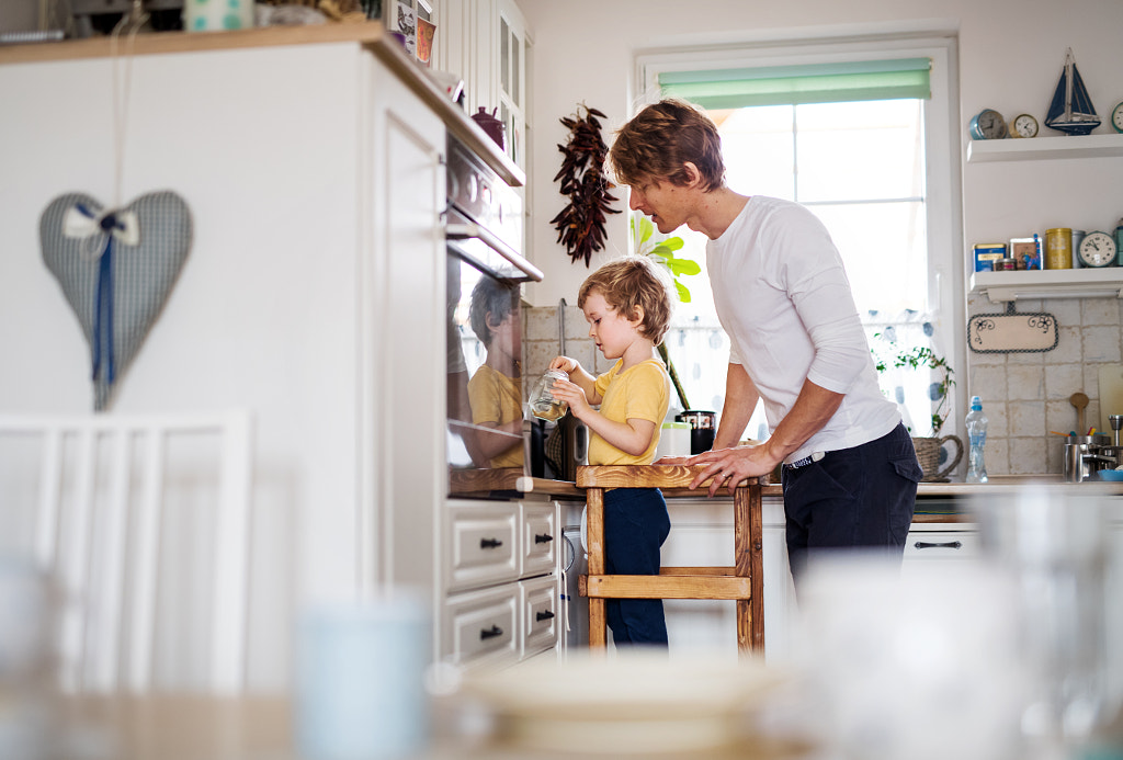 A young father with a toddler son in a kitchen at home. by Jozef Polc on 500px.com