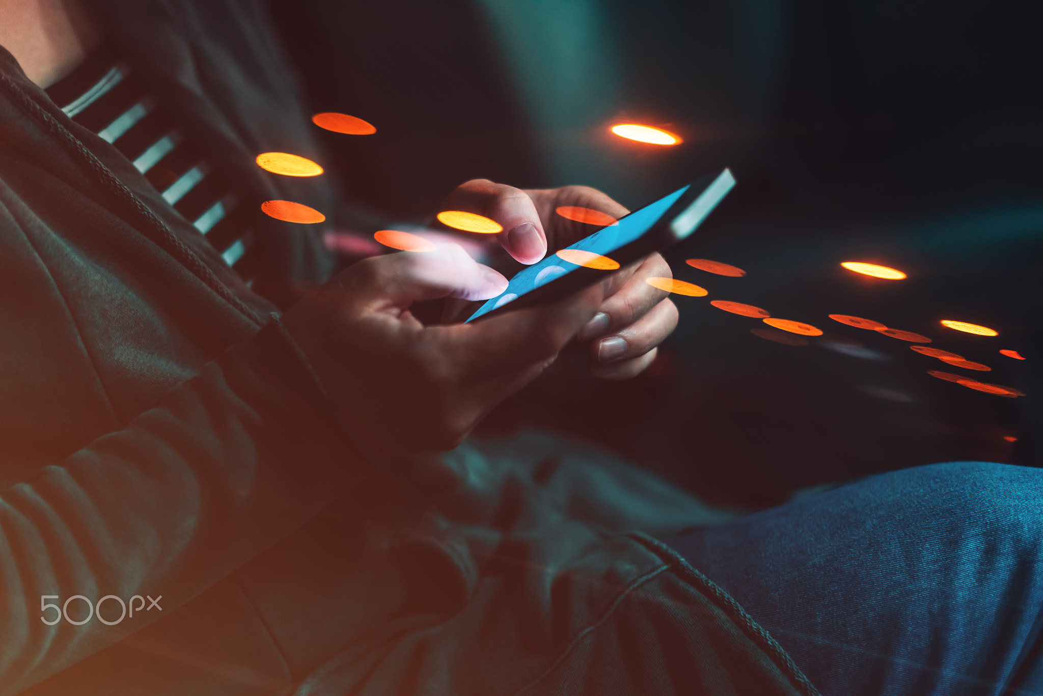 Woman texting on mobile phone in car at night