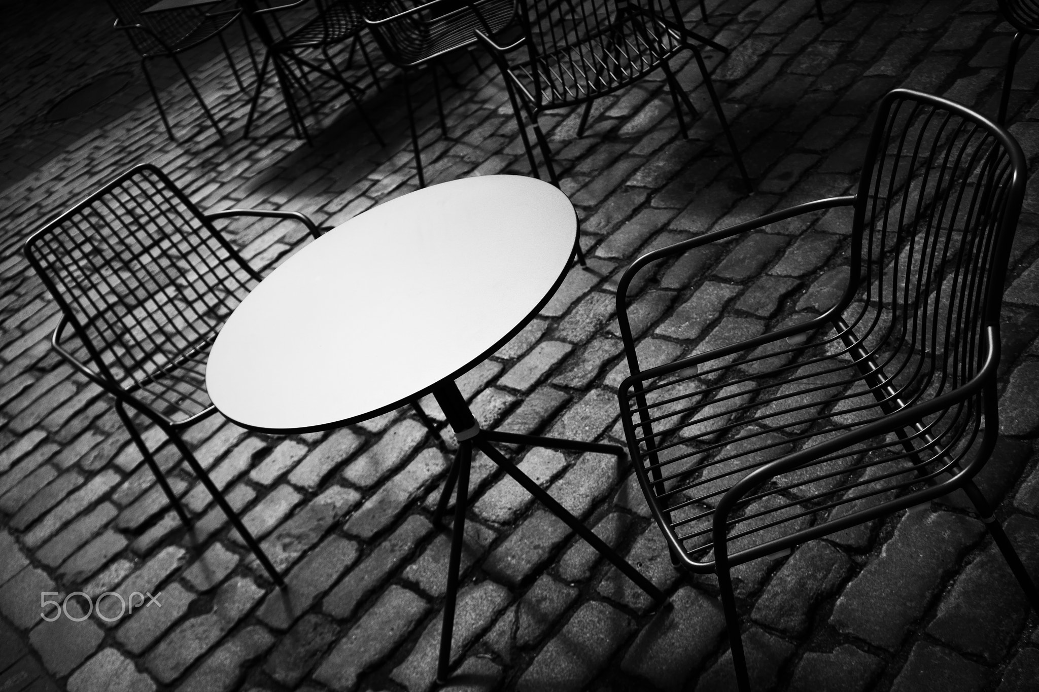 Summer cafe with chairs and a white table