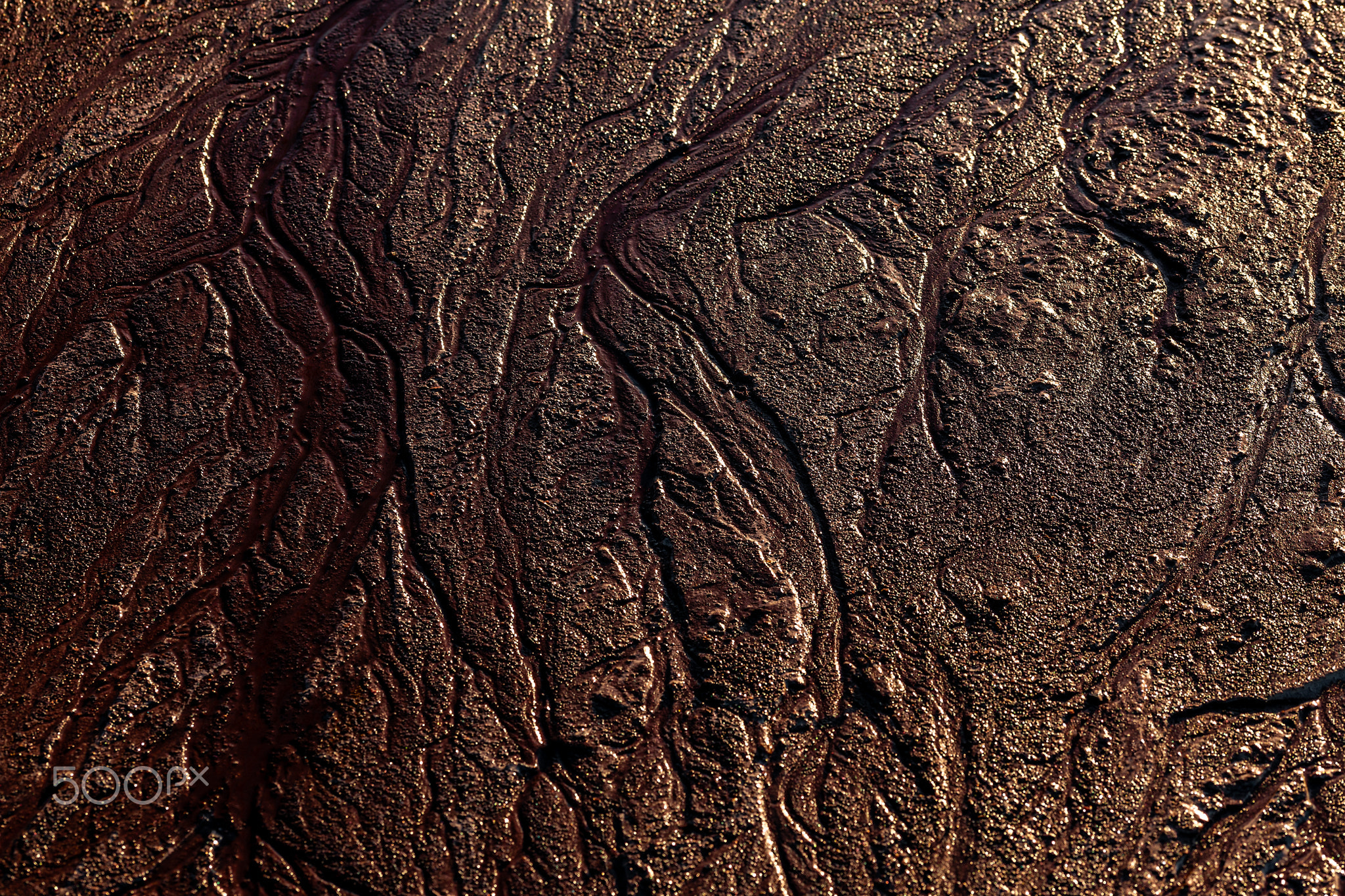 abstract mud background with water washout trails and selective focus