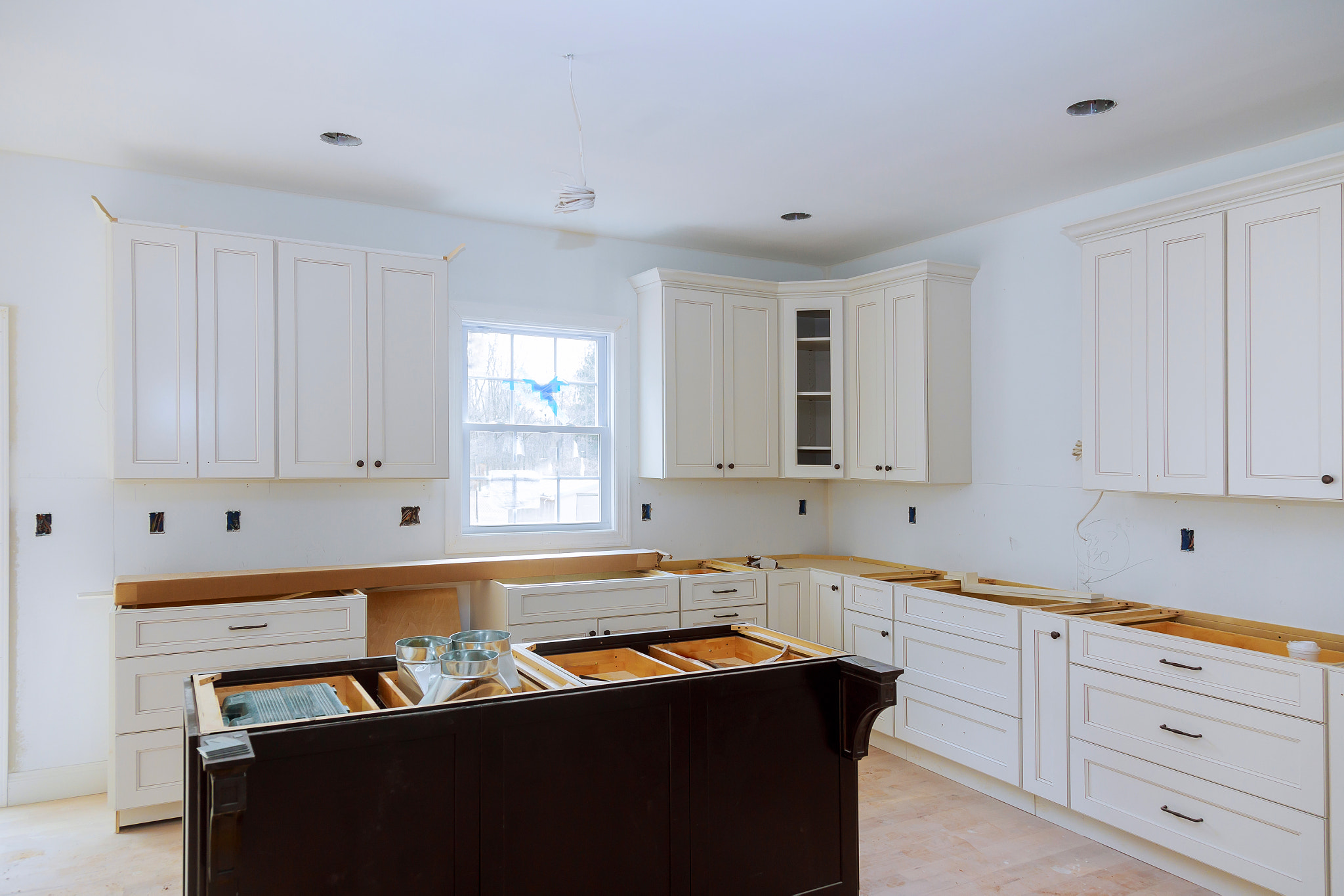 Interior design construction of a kitchen with cabinet maker installing custom