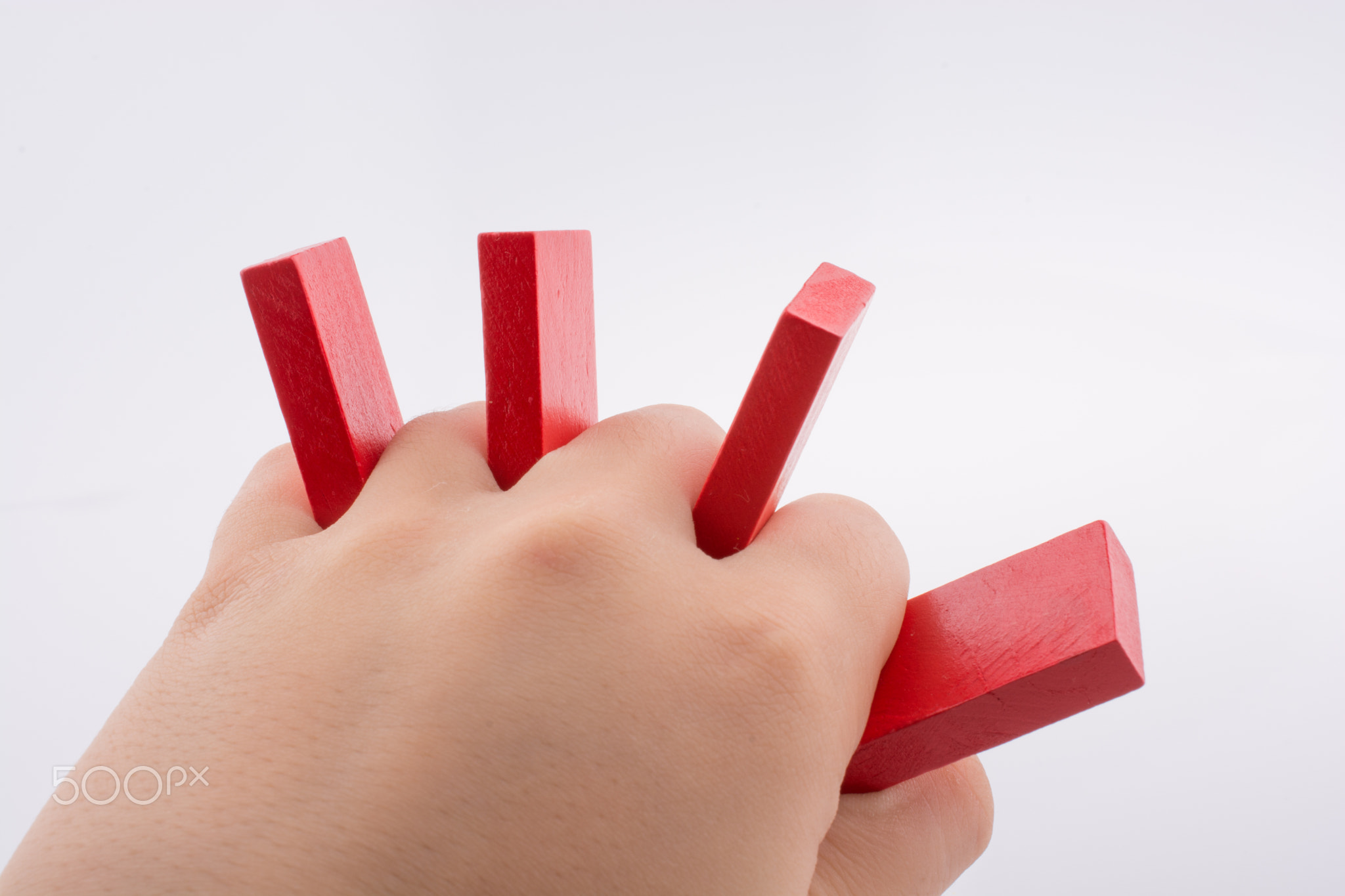 Hand holding color domino pieces in hand