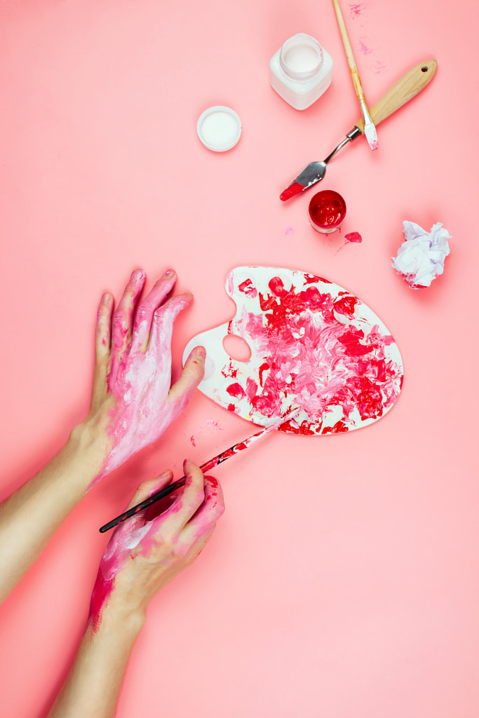 Flatlay with woman's hands covered in paint holding brush and palette and other artist's... by Nataly Lavrenkova on 500px.com