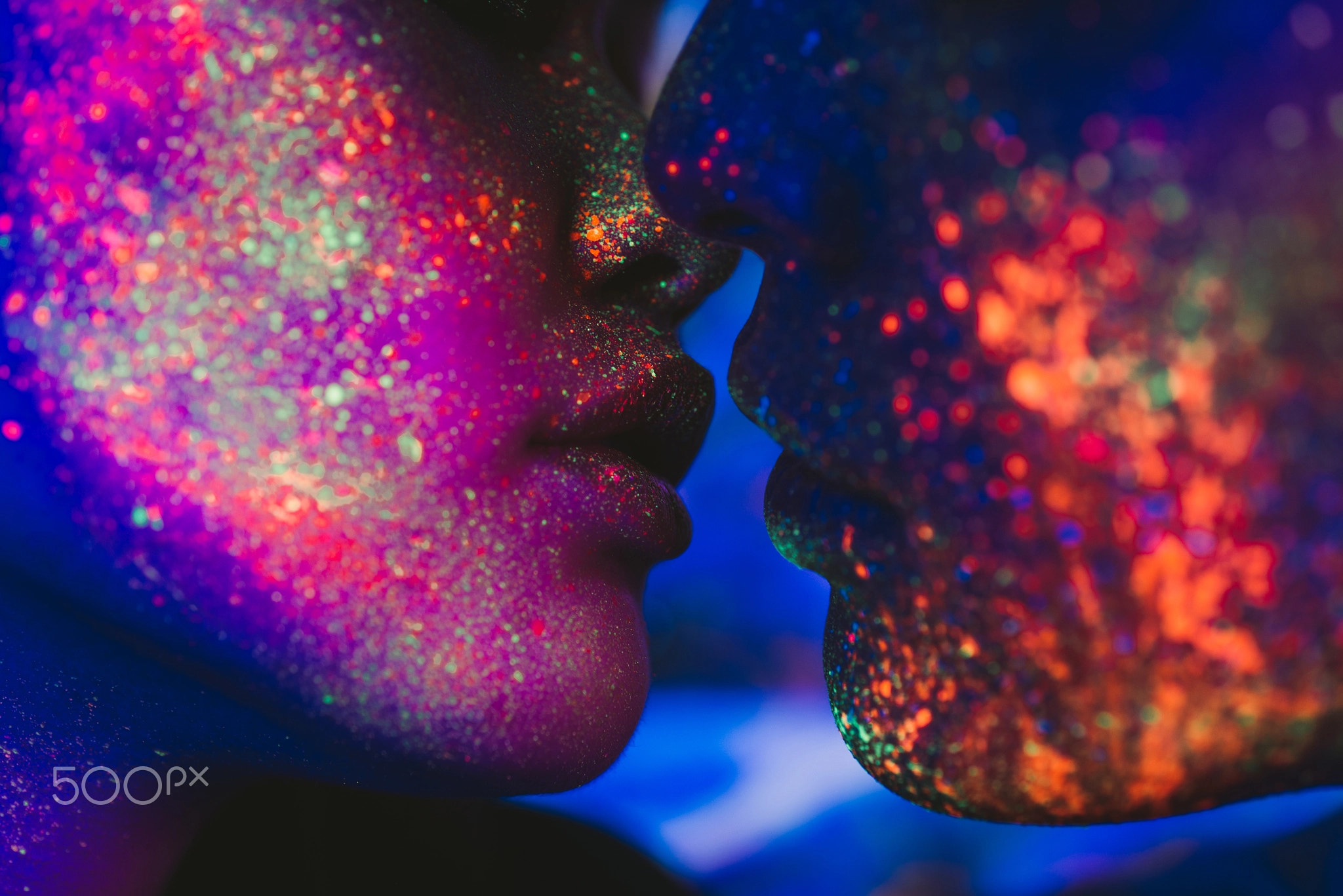 Couple kissing in the disco club with fluorescent paintings on t