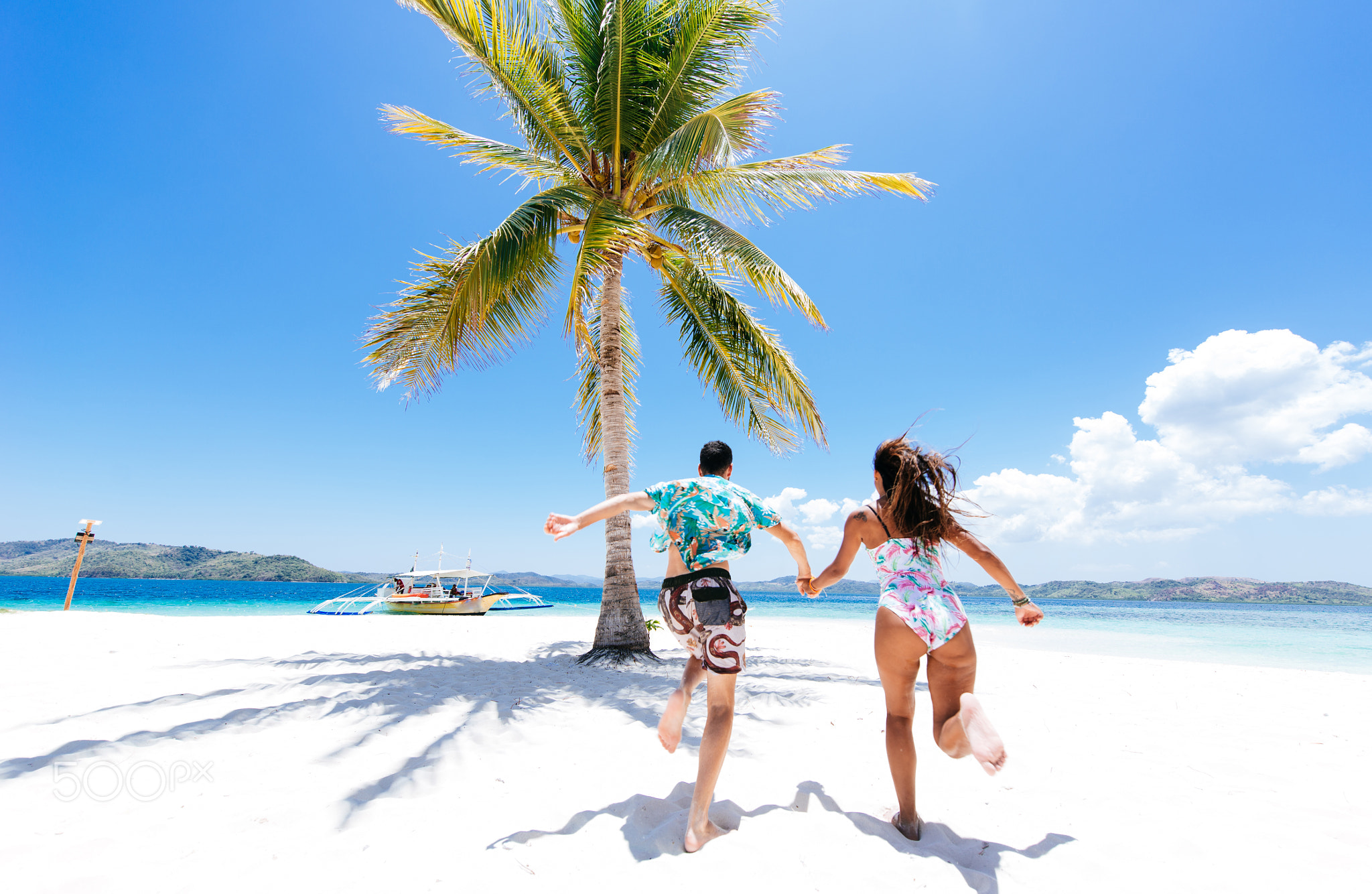 Couple spending time on a beutiful remote tropical island in the