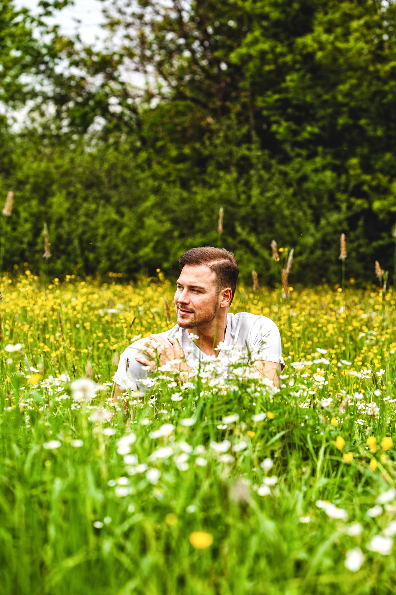 Male student is sitting in the tall grass