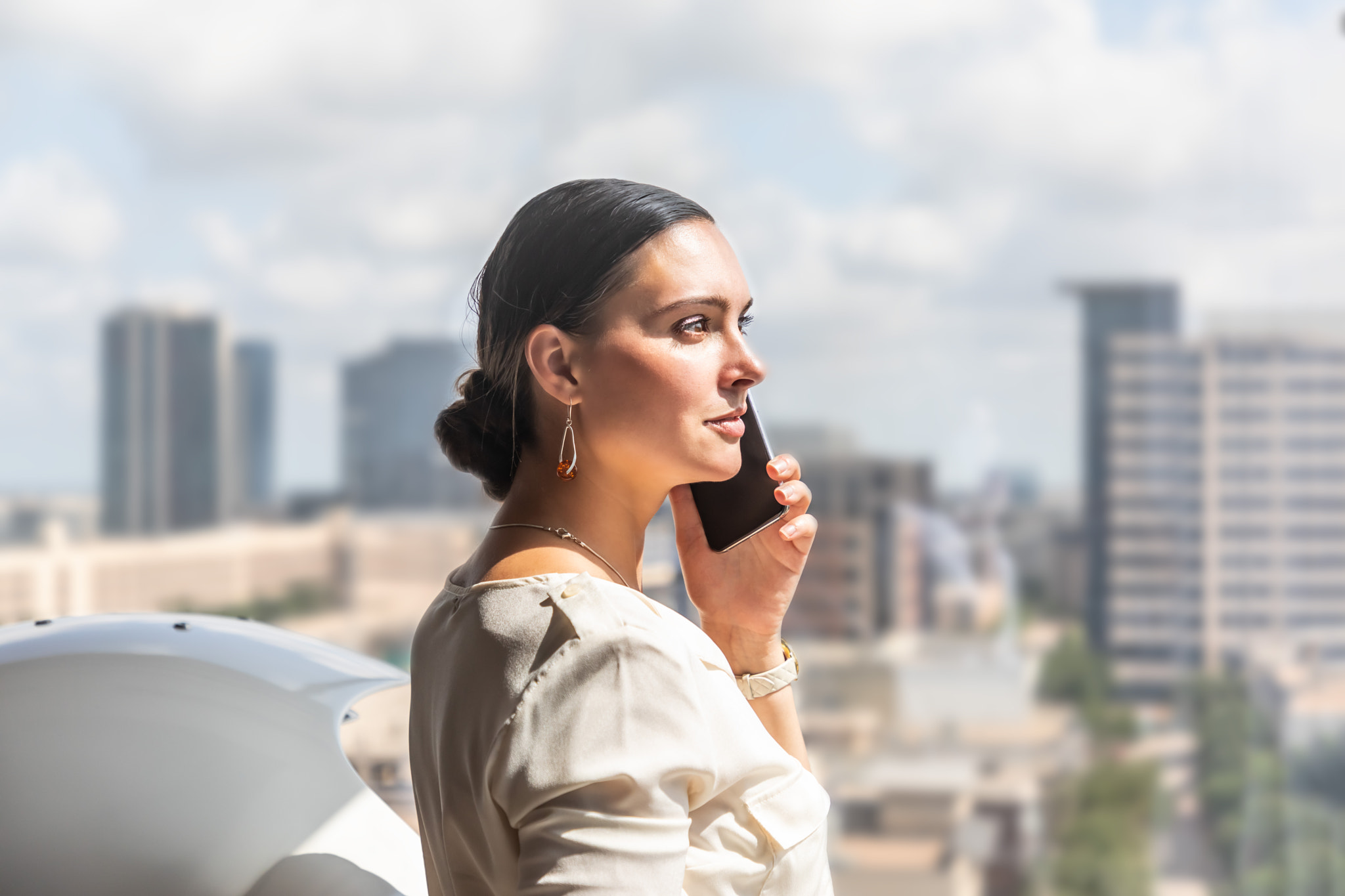 Young proud businesswoman is talking on her mobile phone with a