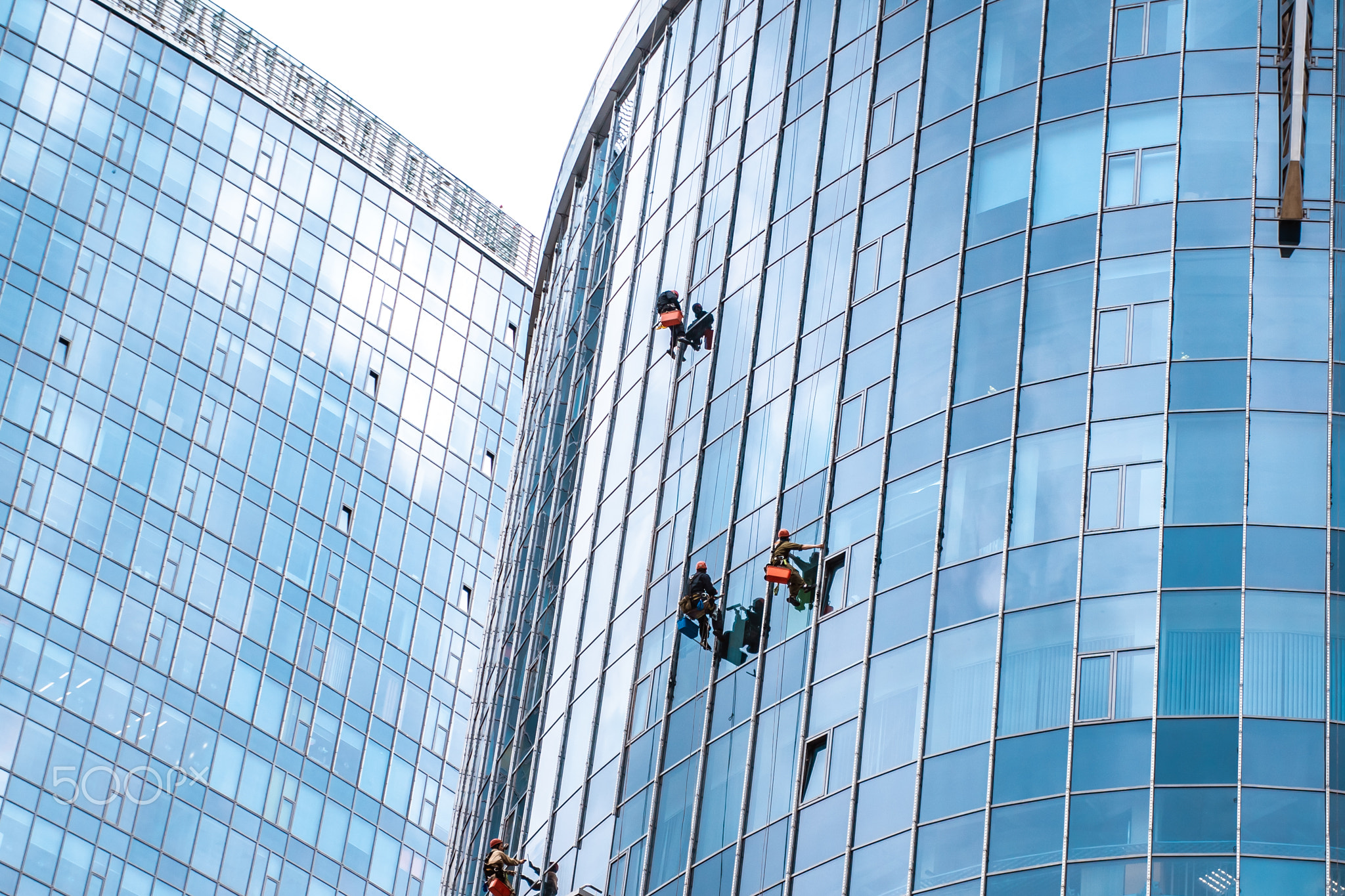 Workers washing windows in the office building