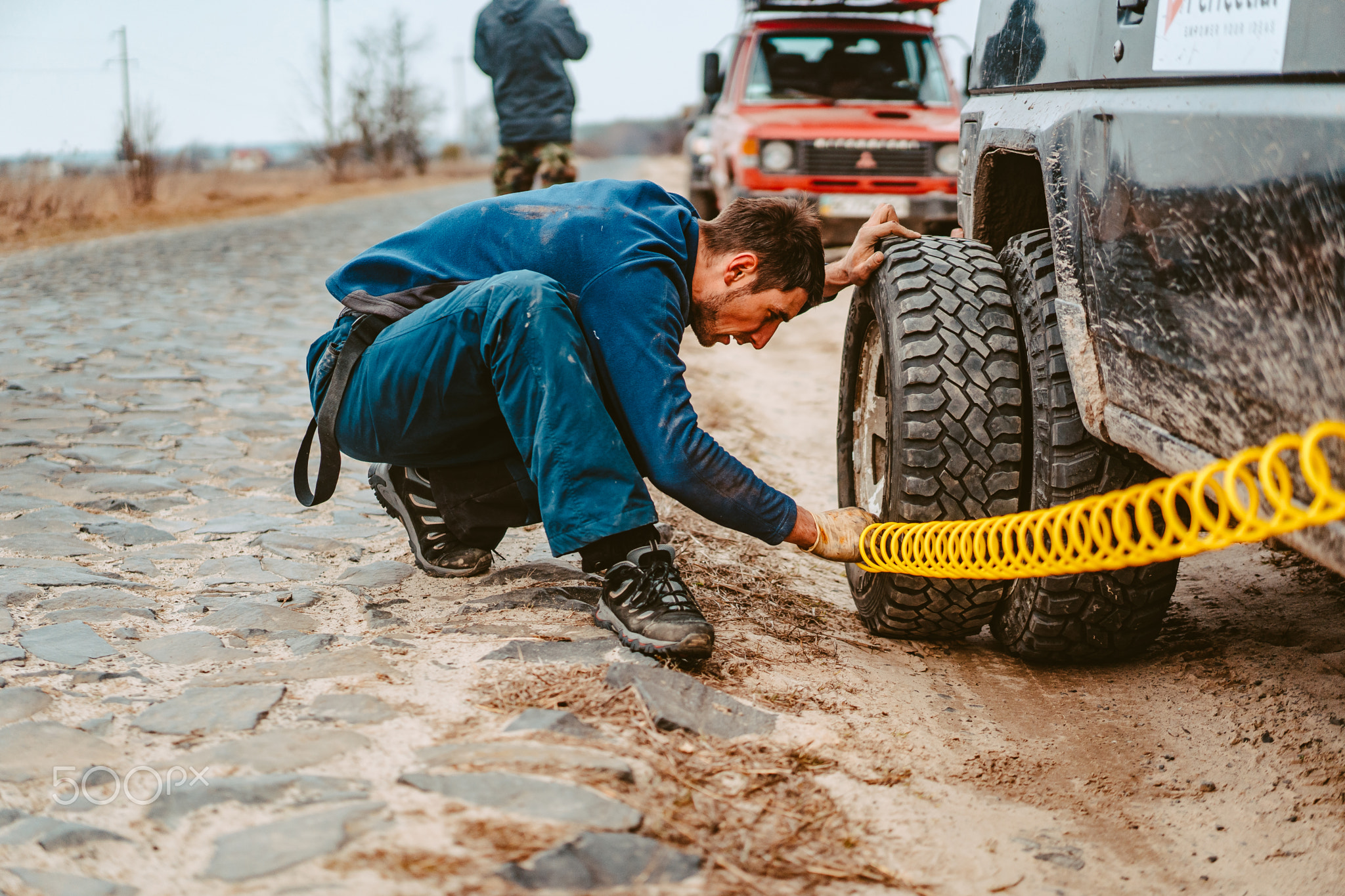 A man pumps air wheel with a compressor