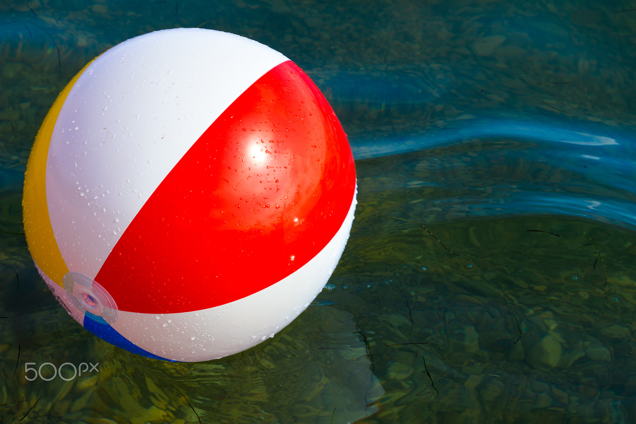 Beach inflatable ball floating in the water