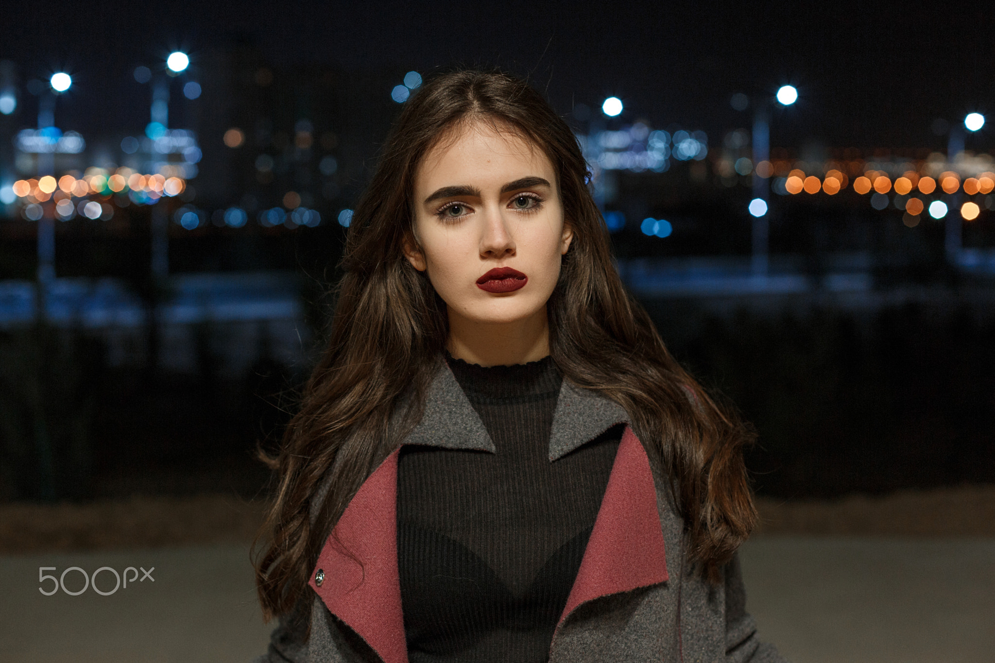 portrait of a young beautiful brunette girl in a gray coat and B