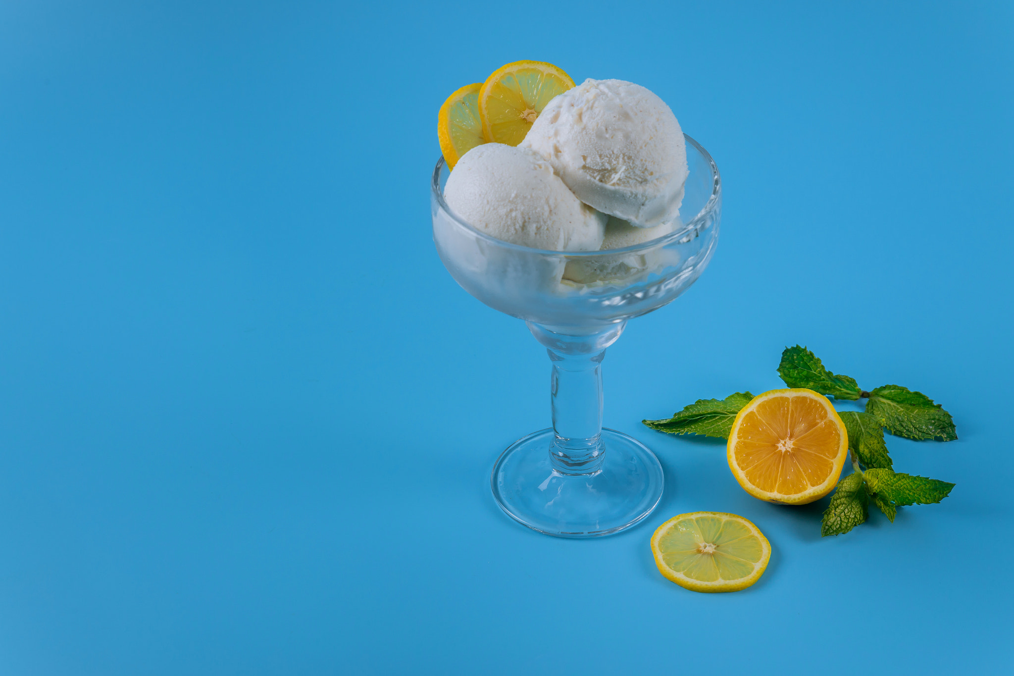 Ice cream with lemon on blue background.