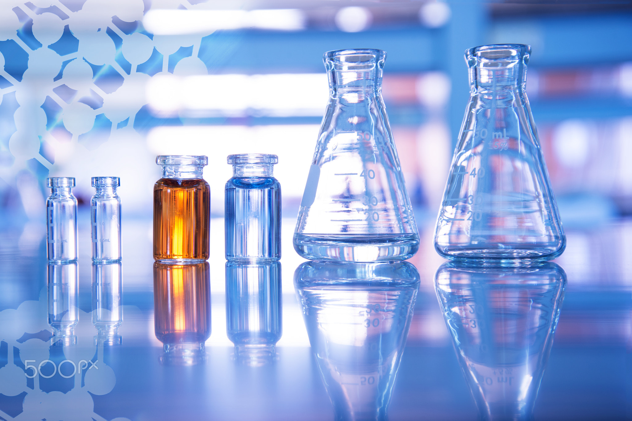 glass flask and blue and orange solution in vial for medical sci