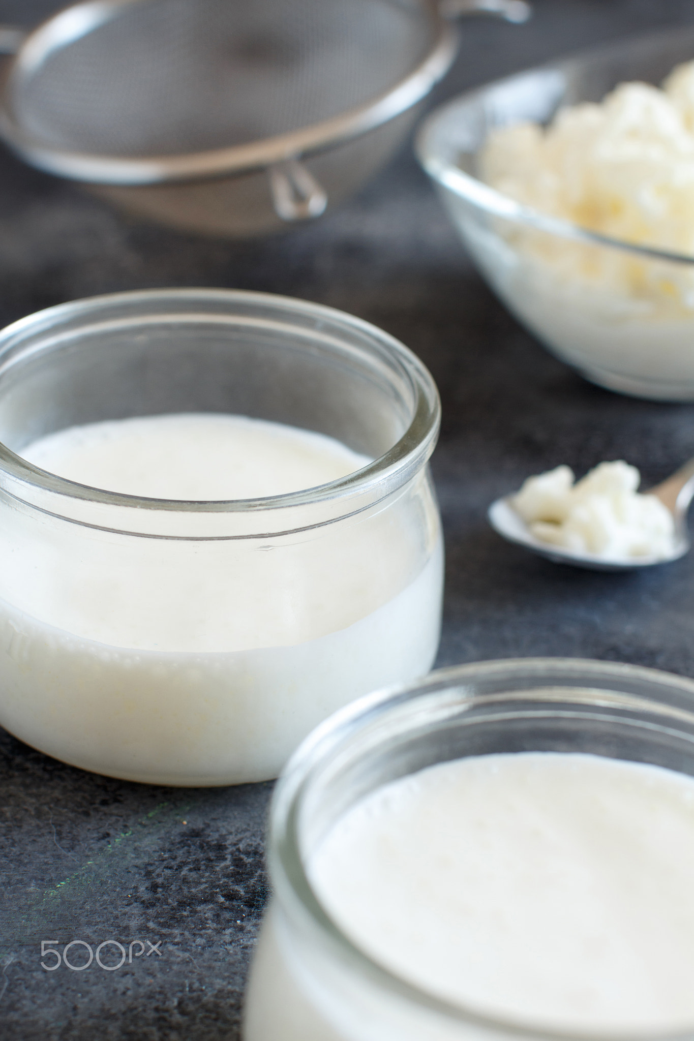 Fermented drink kefir in small bottles and kefir grains