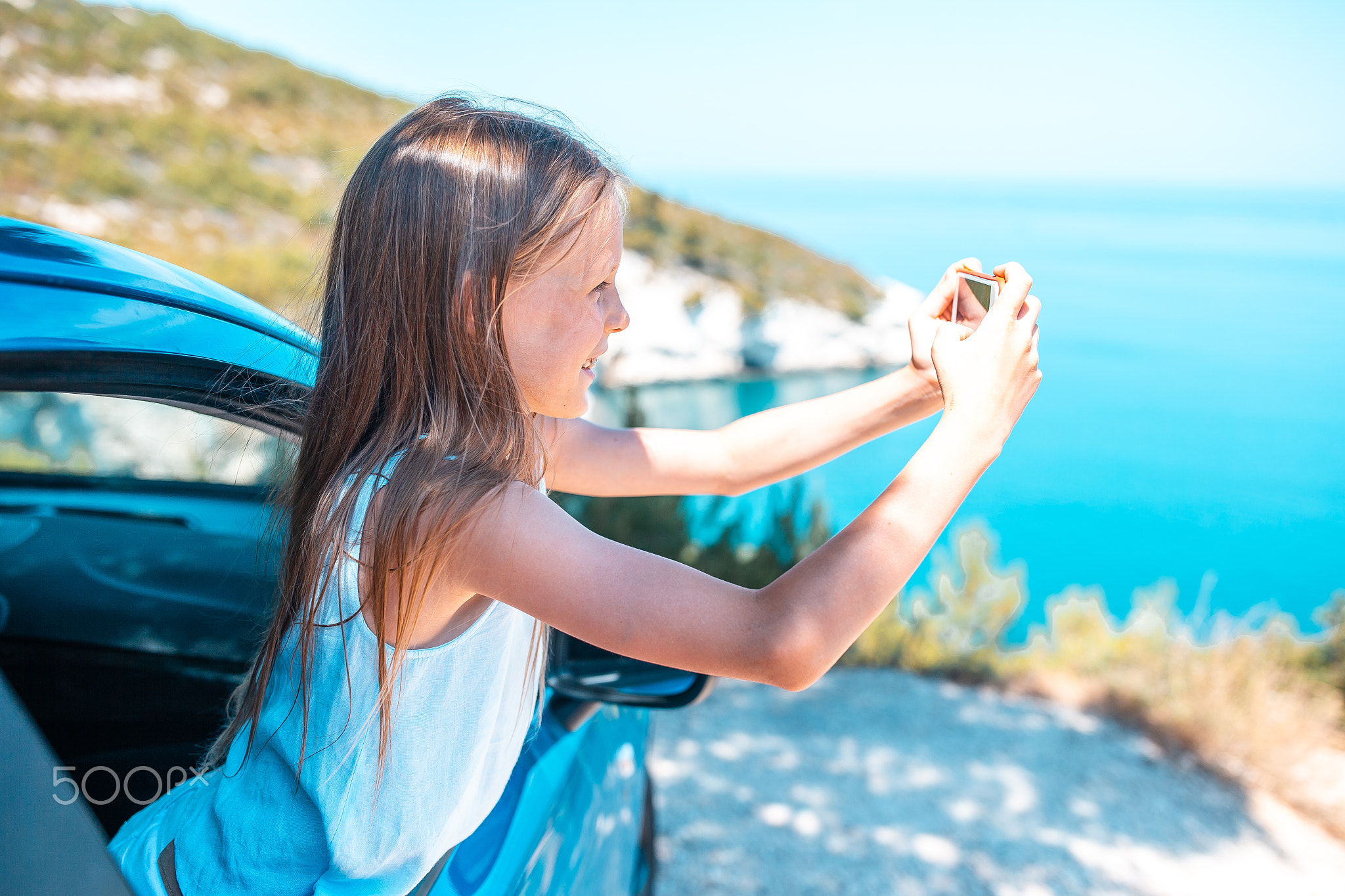 Little girl on vacation travel by car. Summer holiday and car travel concept