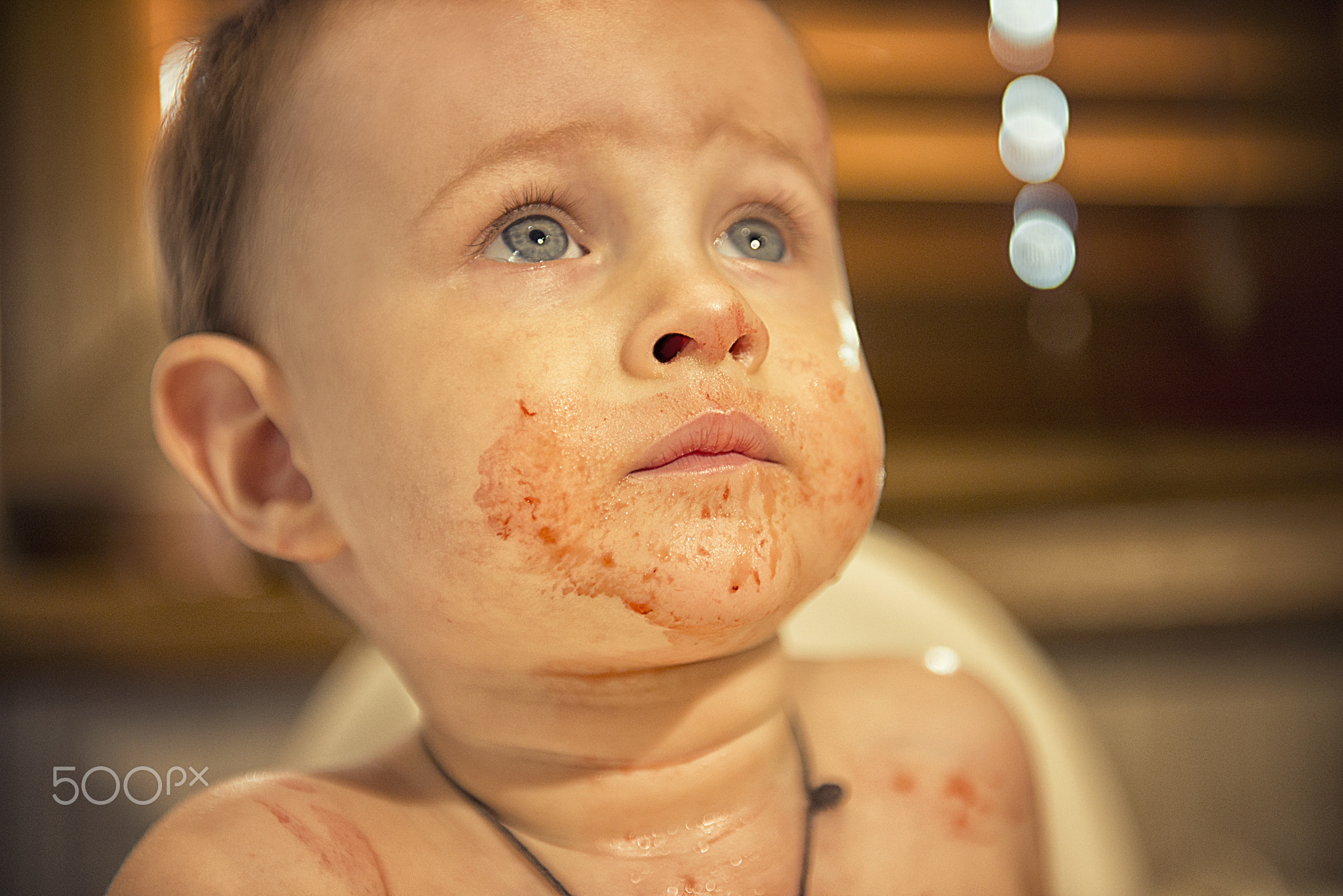 Young boy smeared in strawberry juice and asks for supplements