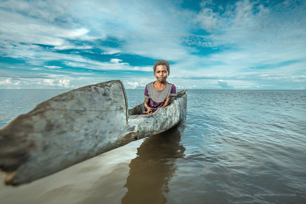 a Papuan girl on the ocean