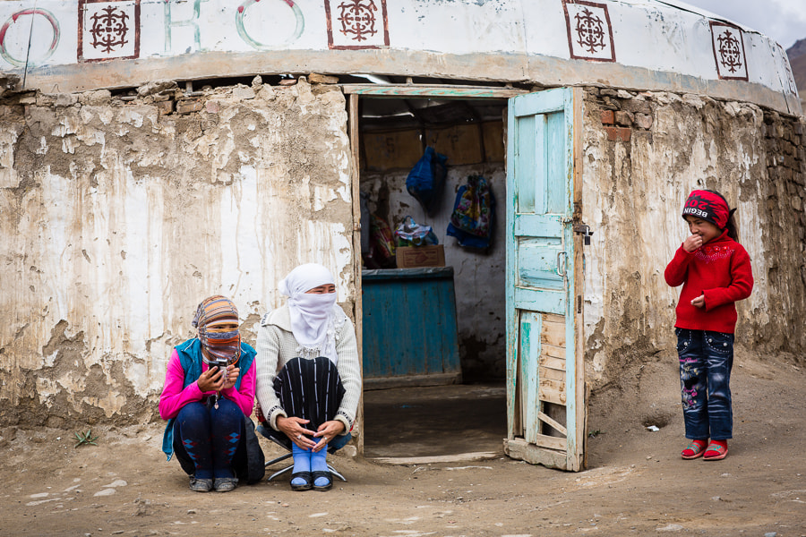 Three Kyrgyz girls outside shop