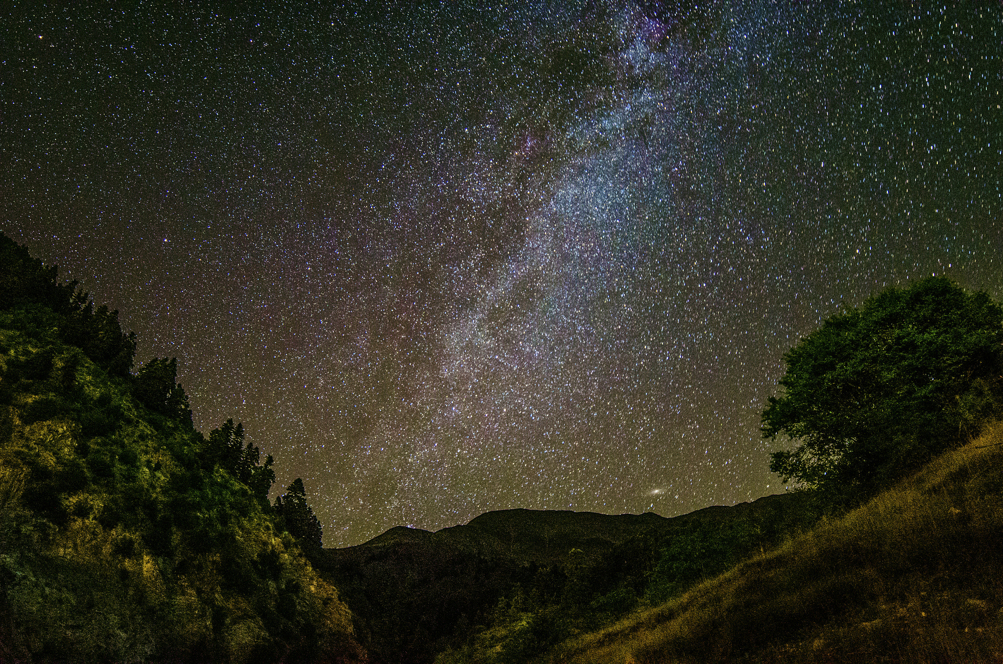 The milky way and the Andromeda galaxy above the mountains