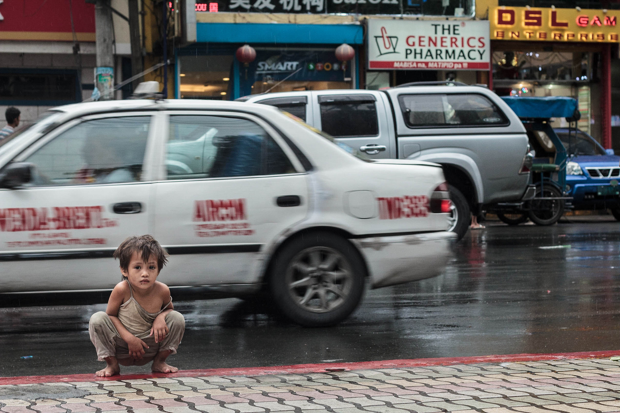 Child Peeing on the Sidewalk by Danielle Ayag / 500px