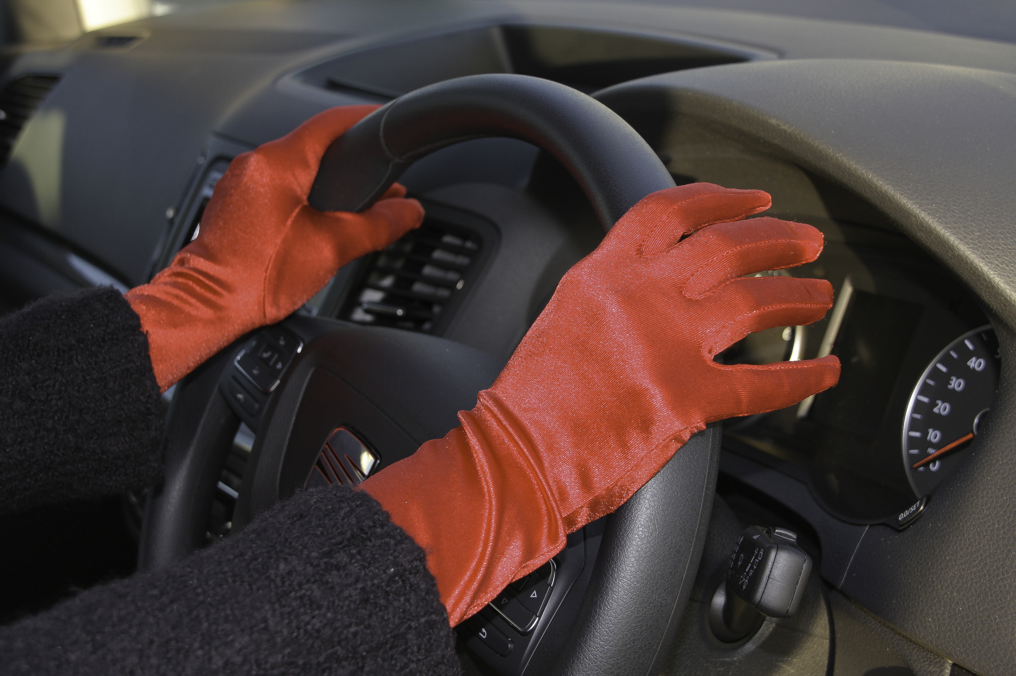 Red Gloves on Steering Wheel