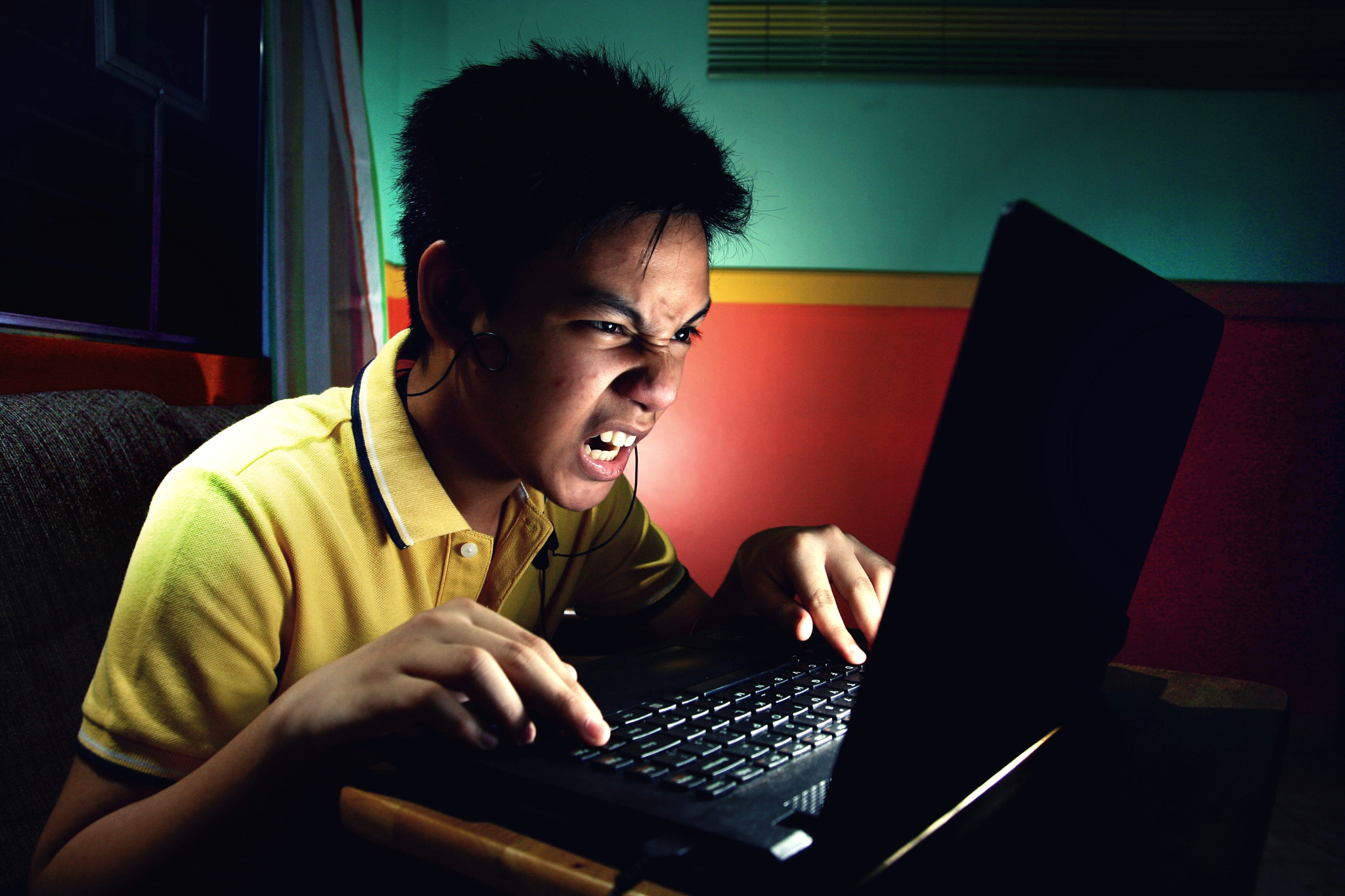 asian boy with a laptop computer