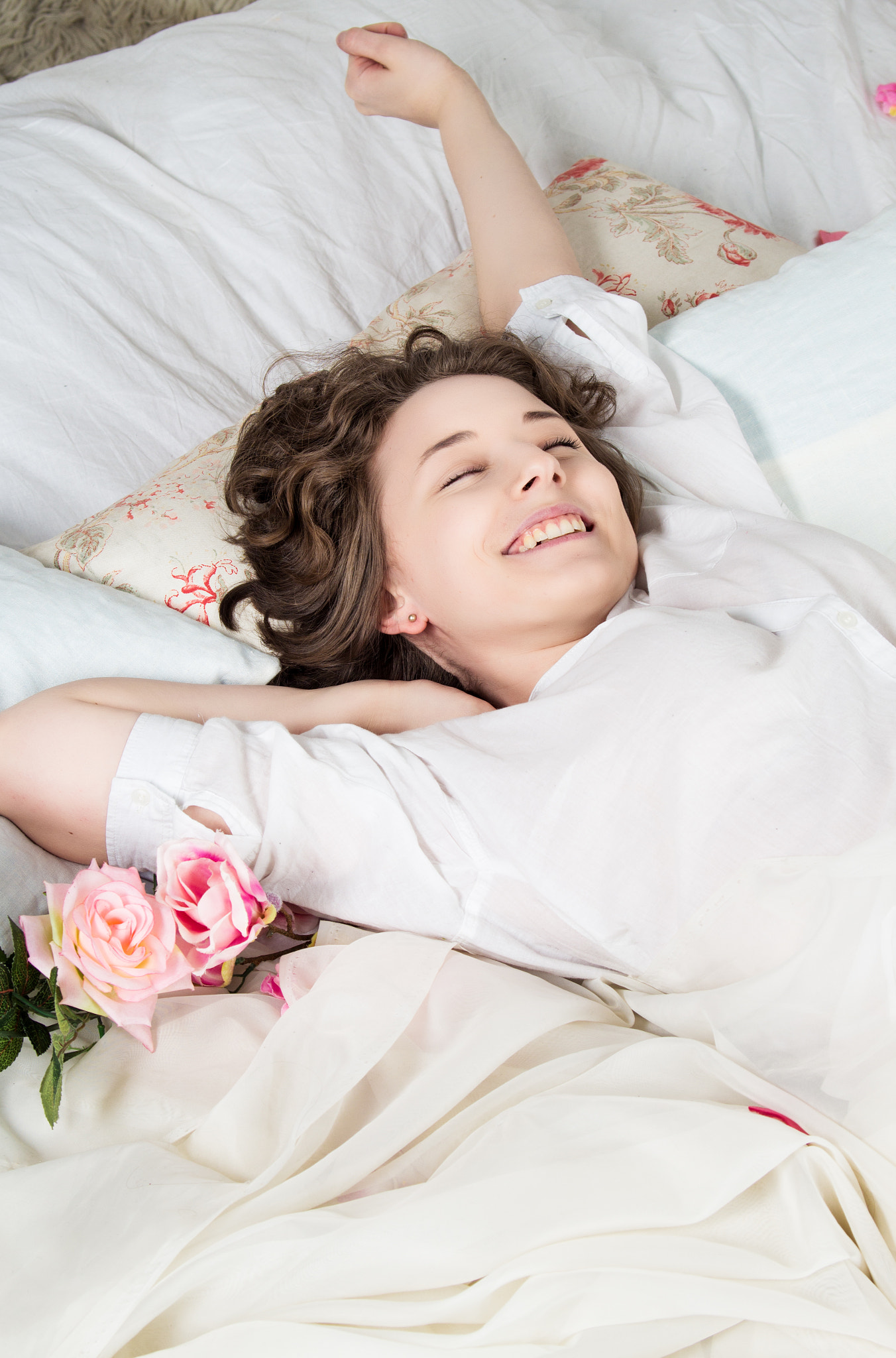 Sweet curly girl wakes up at morning