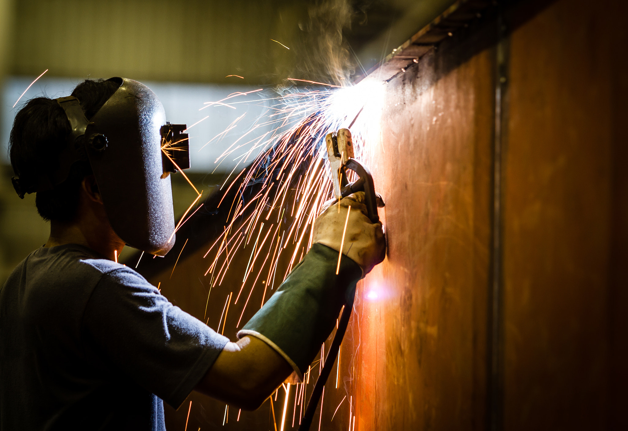 worker with protective mask welding