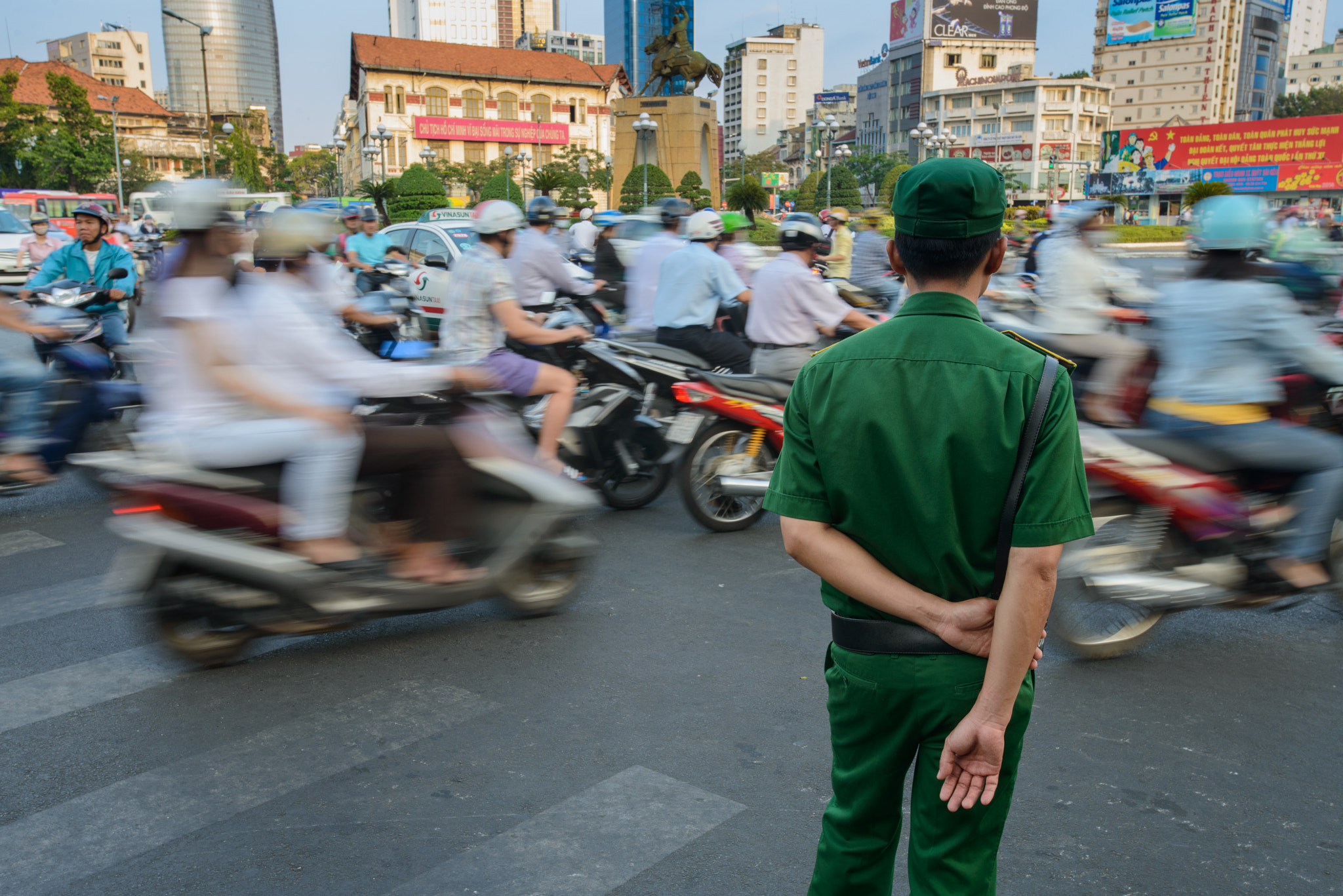 Police Officer Watches the Swell of Traffic During Peak Hour