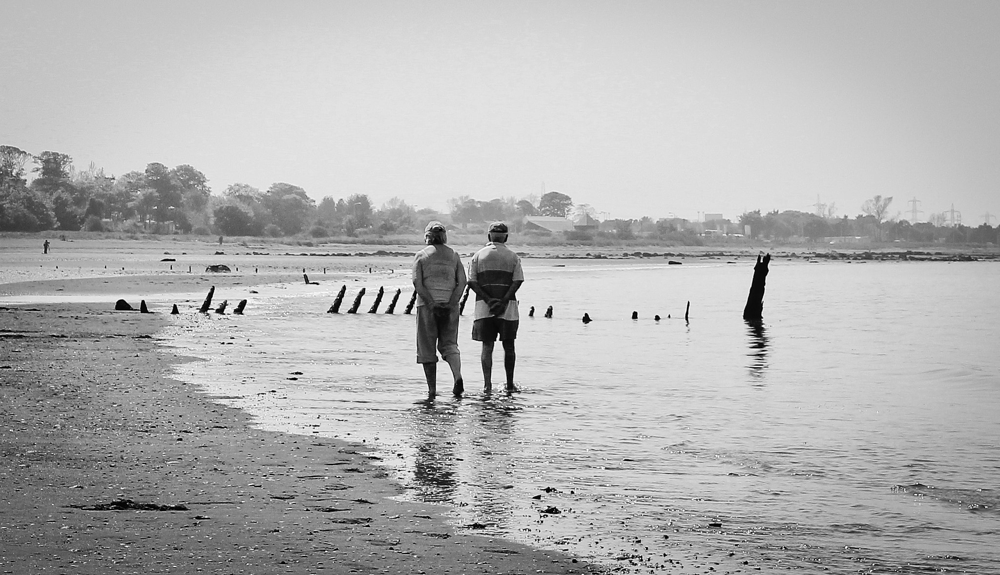 Older couple walking on beach
