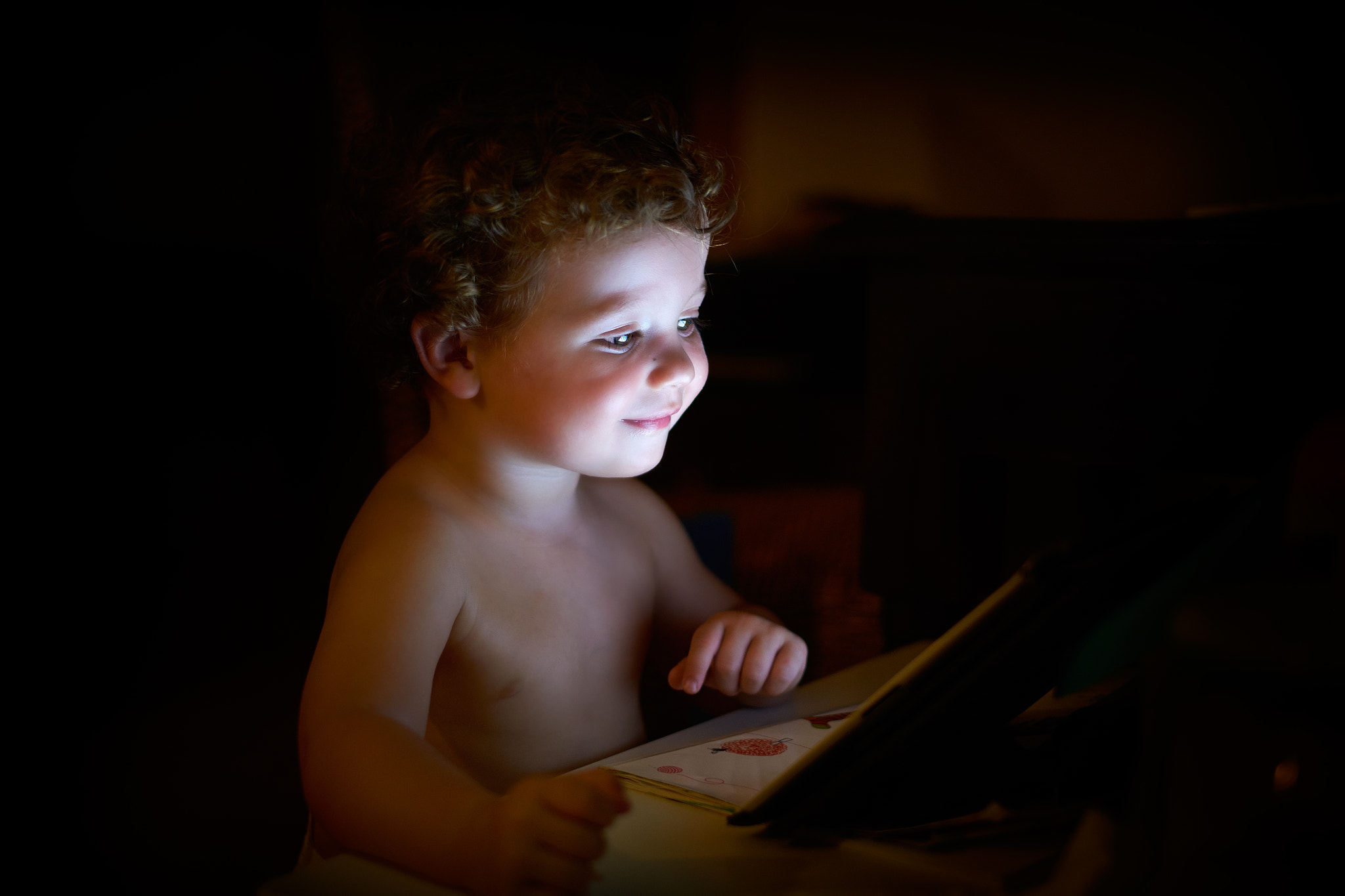 Kid enjoys a tablet