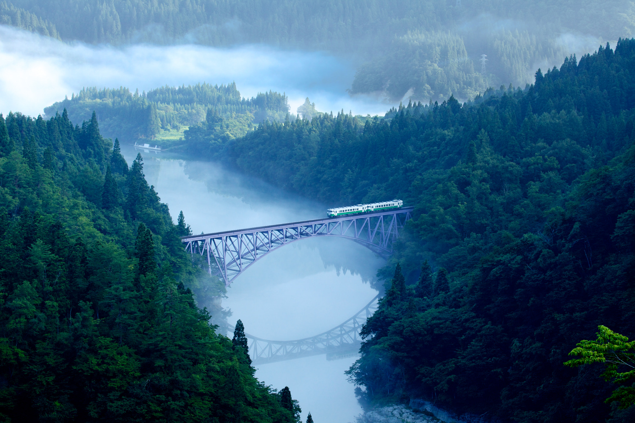 First train goes on river mist