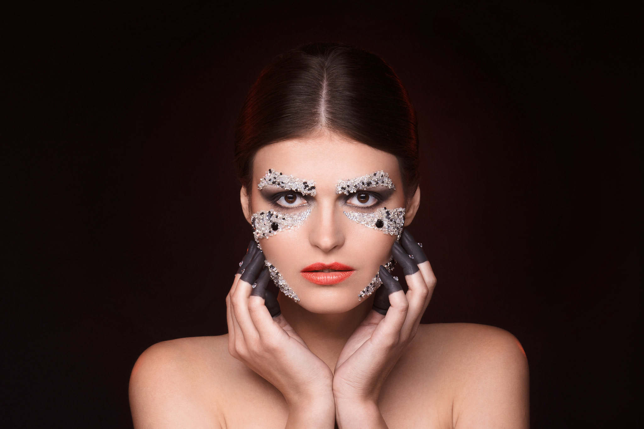 Beautiful woman with crystals makeup keep her hands near face by Dmytro ...