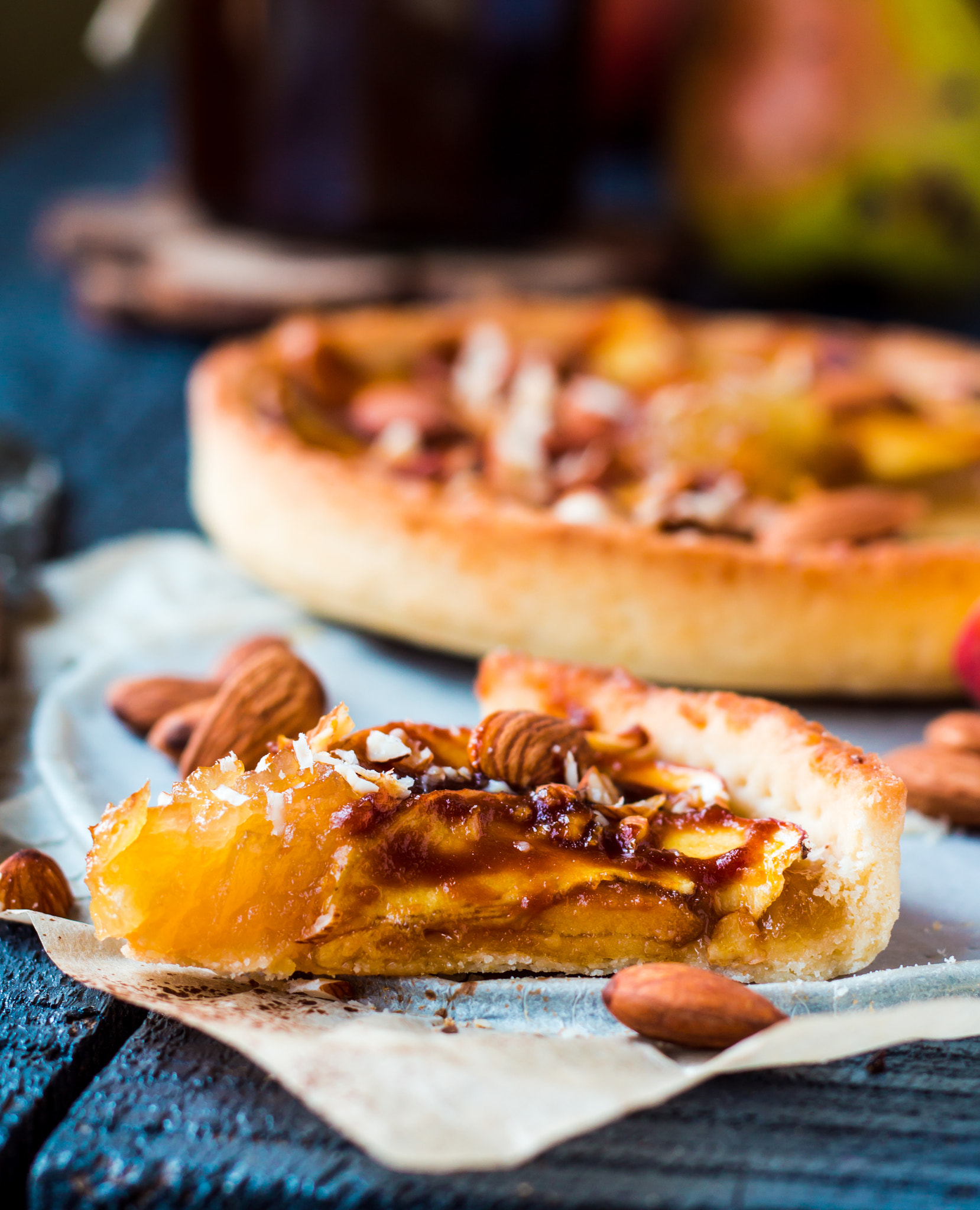 apple tart on a sand base with caramel on parchment