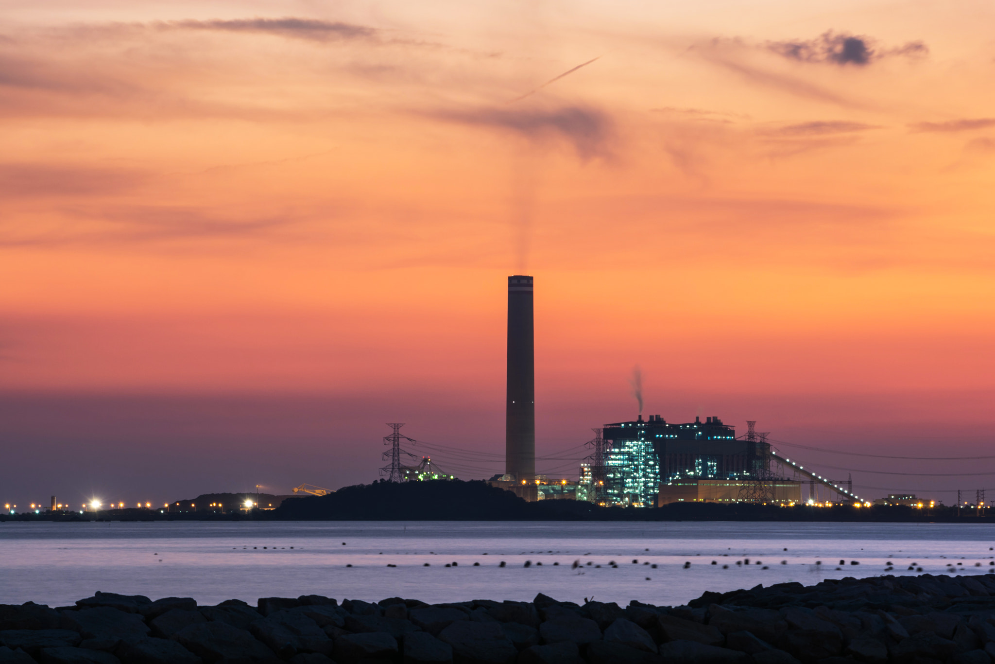 Power plant factory silhouette over sunset