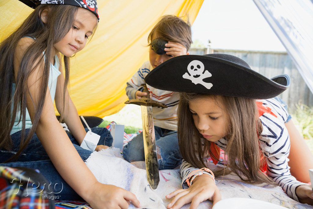 Children playing pirates and viewing treasure map