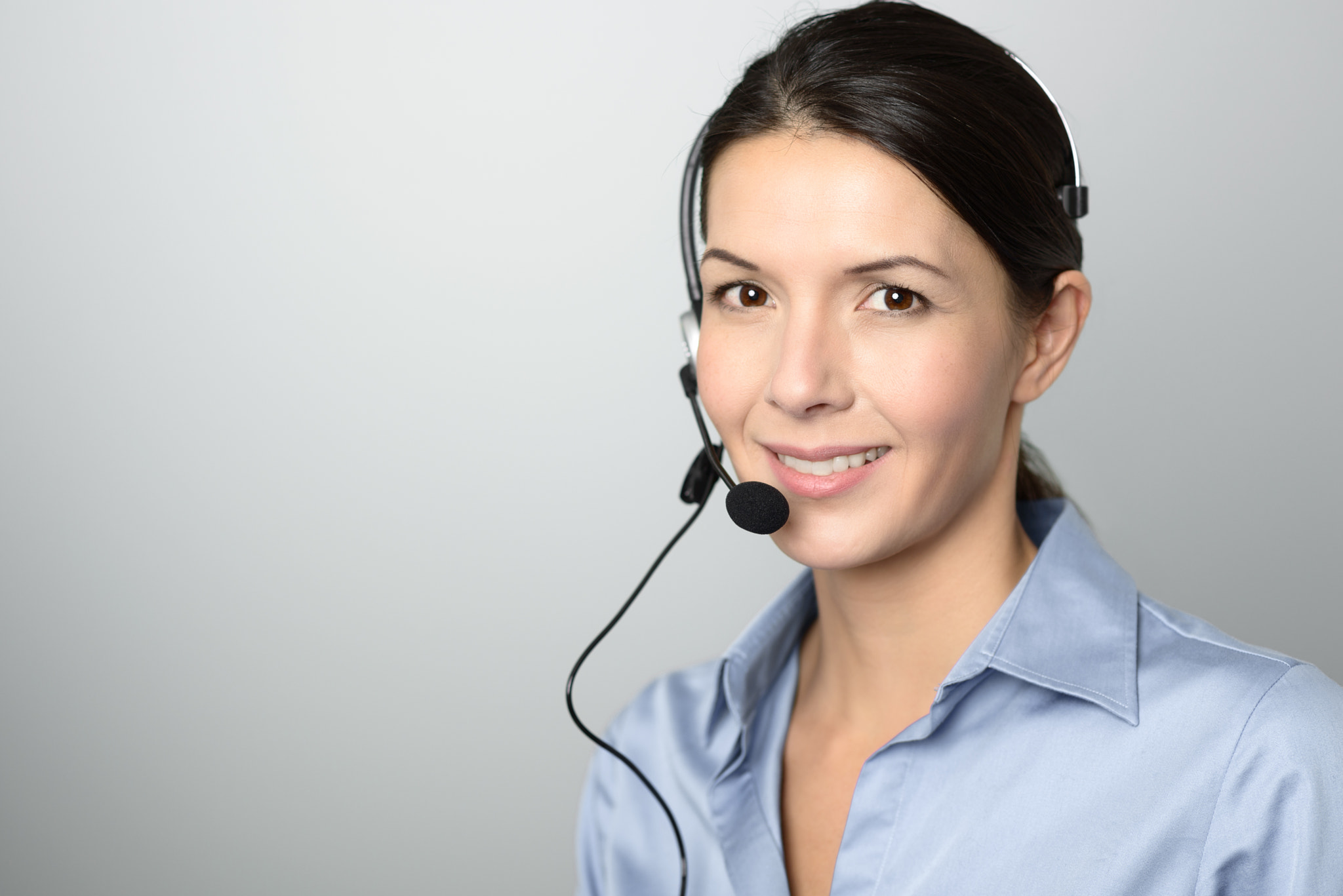 Attractive call center operator wearing a headset