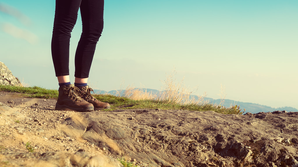 Unrecognizable female hiker on top of the mountain wearing hiking boots, Ben A'an, Loch Katrina, Hig by Andrea Obzerova on 500px.com