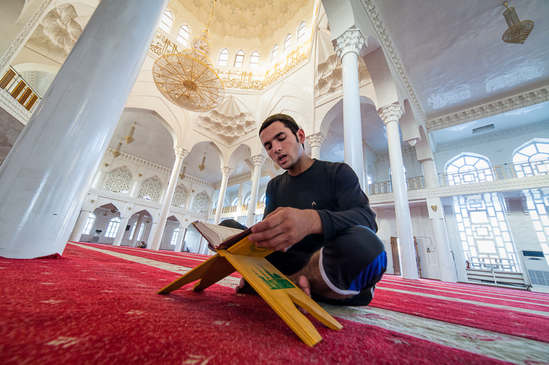 Tajik man reciting the Qur'an in mosque by Damon Lynch on 500px.com
